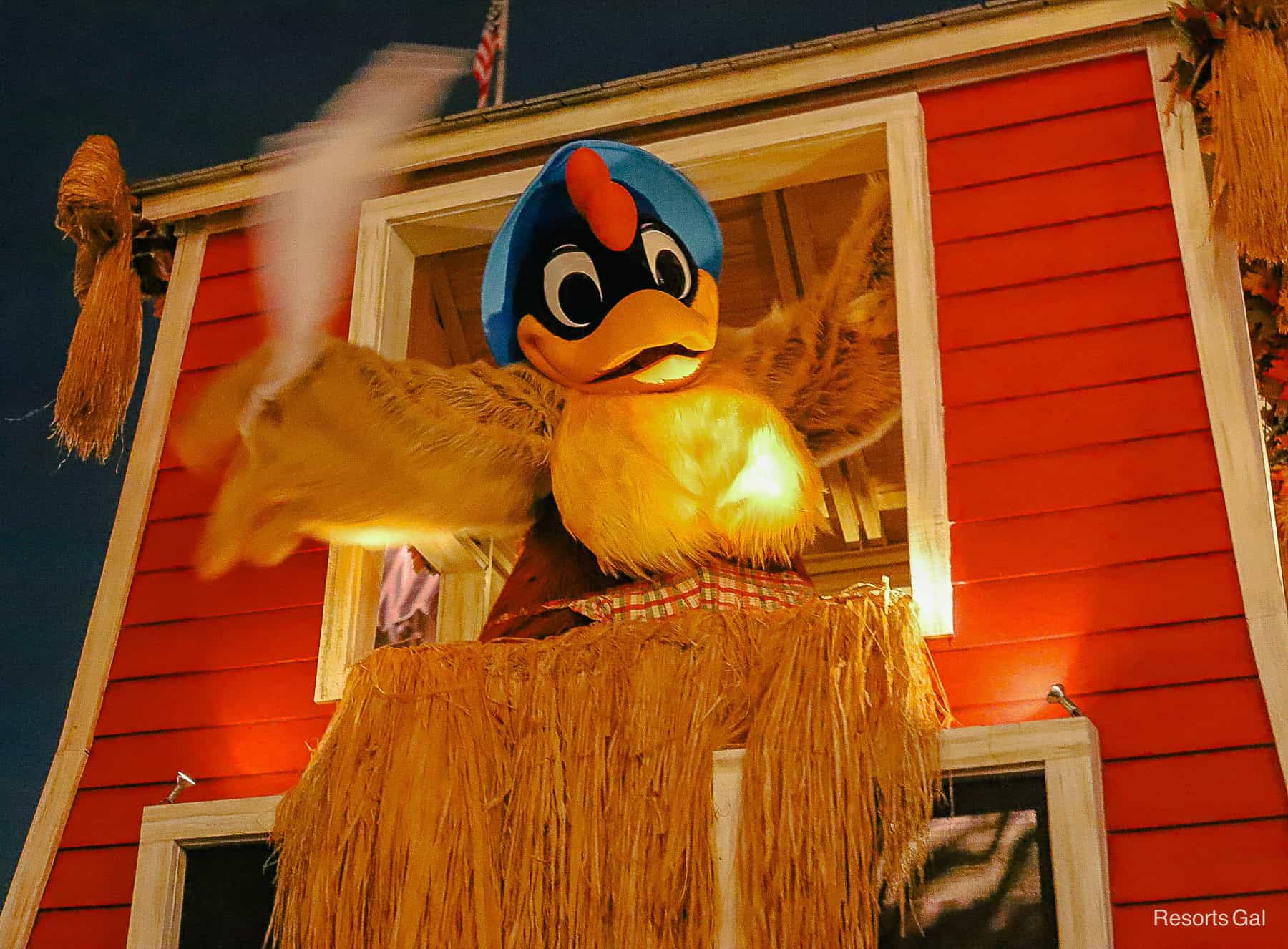 Clara waves with feather in hand from her hen house float. 