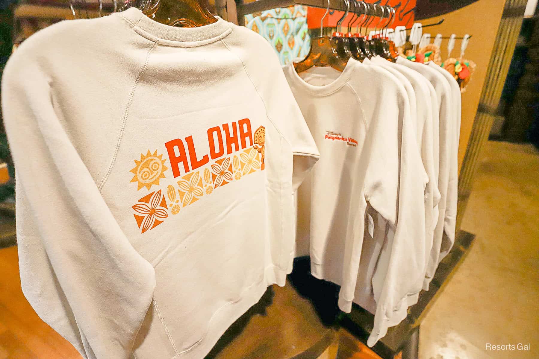 the front and back of an Aloha sweatshirt that represents the Polynesian Village Resort 