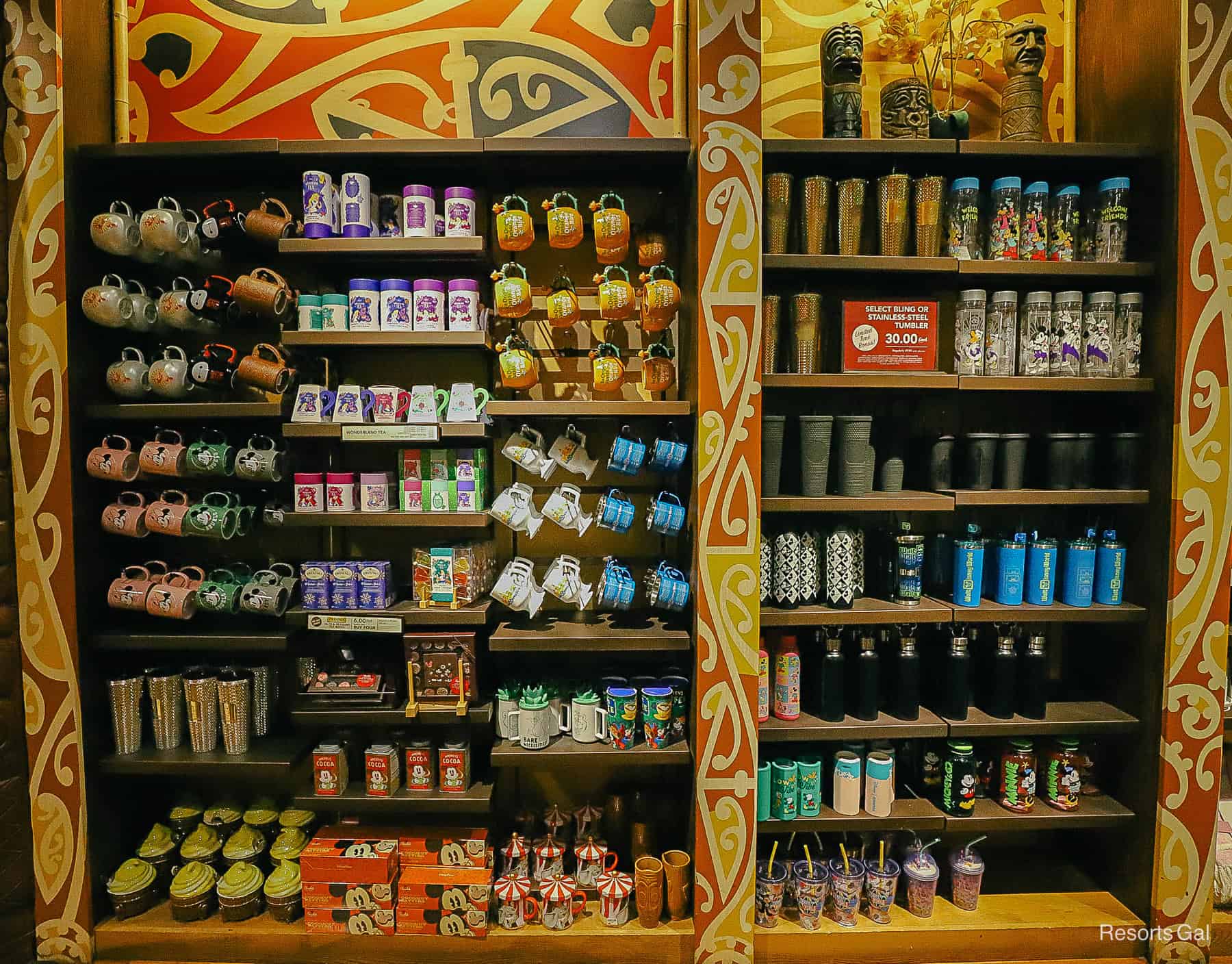 a display with coffee mugs and tumblers 