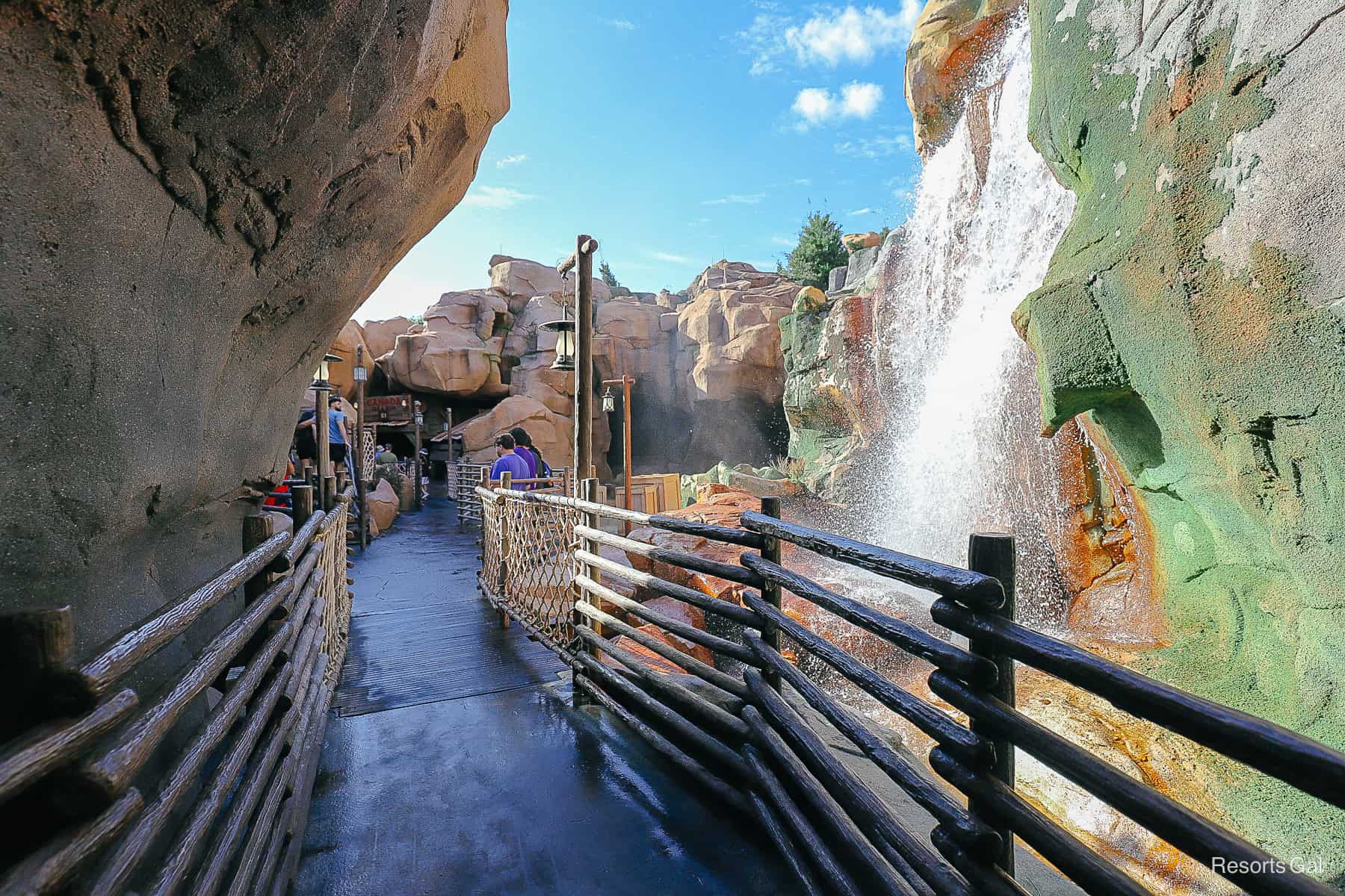 a walkway at the bottom of the canyon between the attraction and the gardens in Epcot's Canada Pavilion 