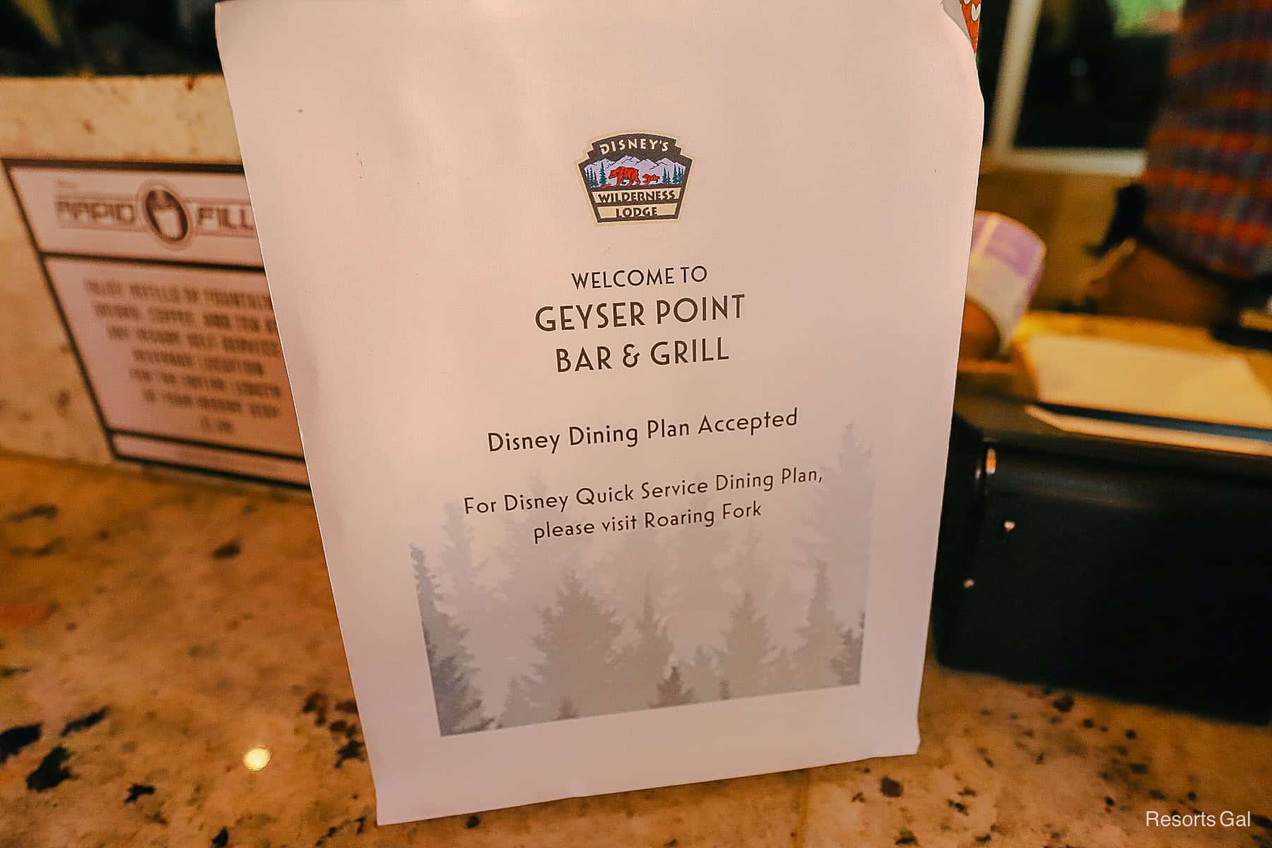 a sign that tells guests that the Disney Dining Plan is accepted at Geyser Point but the Quick Service Dining Plan is not 