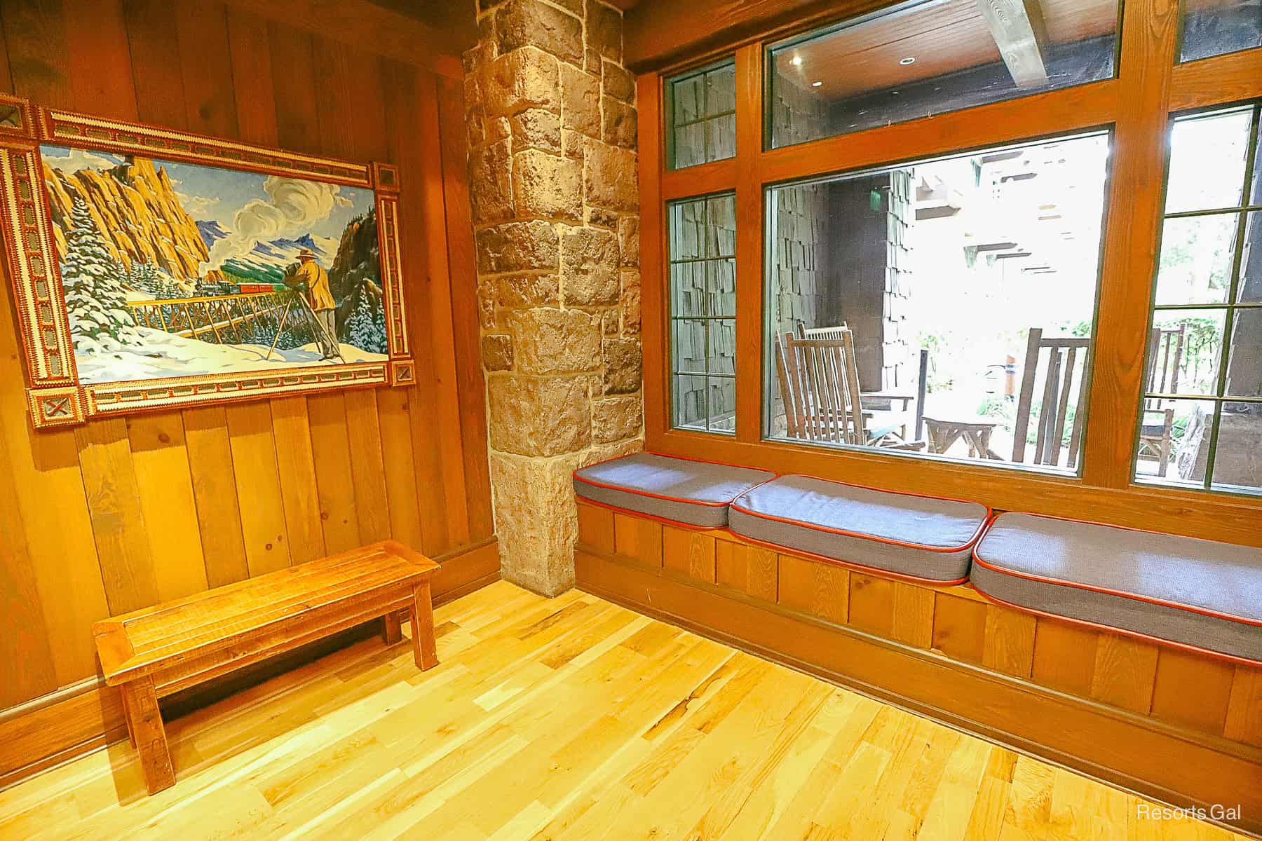 a corner setting with a bench seat and artwork in the Carolwood Train Room 