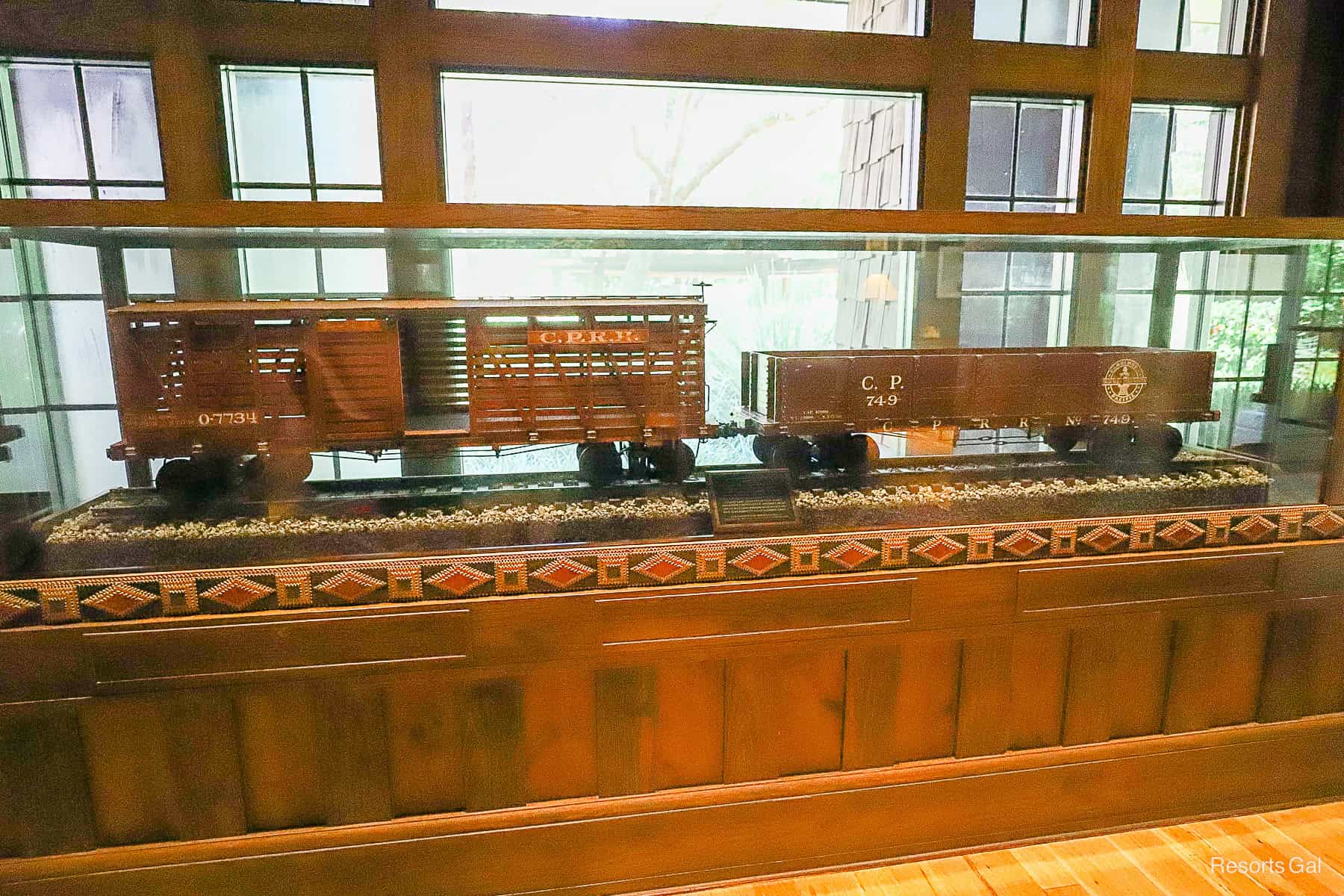 two of the train cars that were part of Walt Disney's backyard train when he lived on Carolwood on display in the Carolwood Railway Room at Disney World 