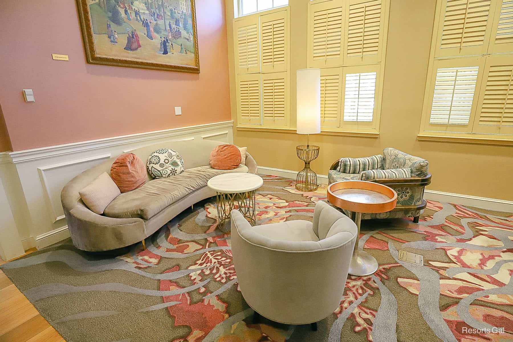 a seating arrangement with chairs, a sofa, and tables in the lobby 