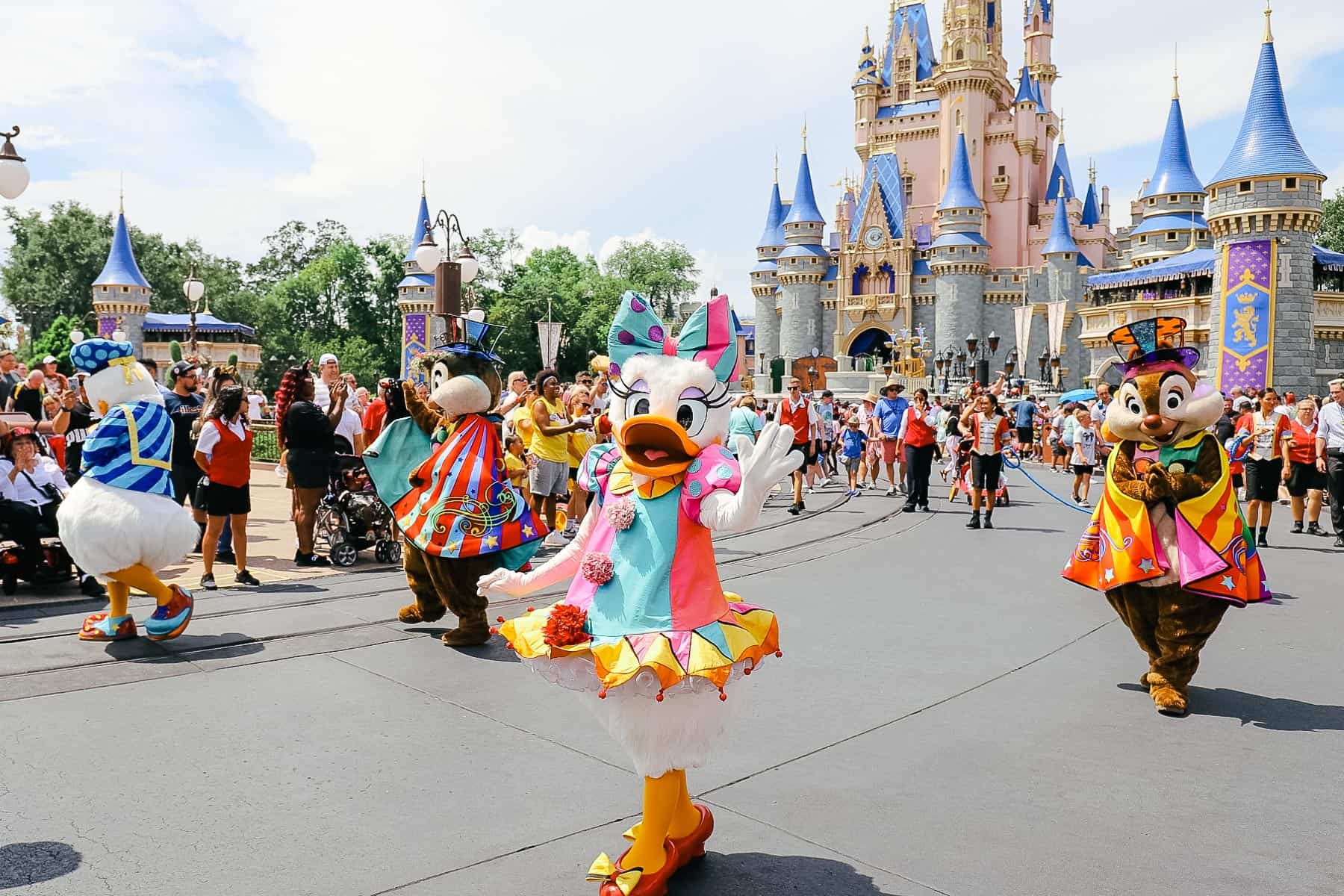 End character in the parade including Chip and Dale with capes and top hats. 