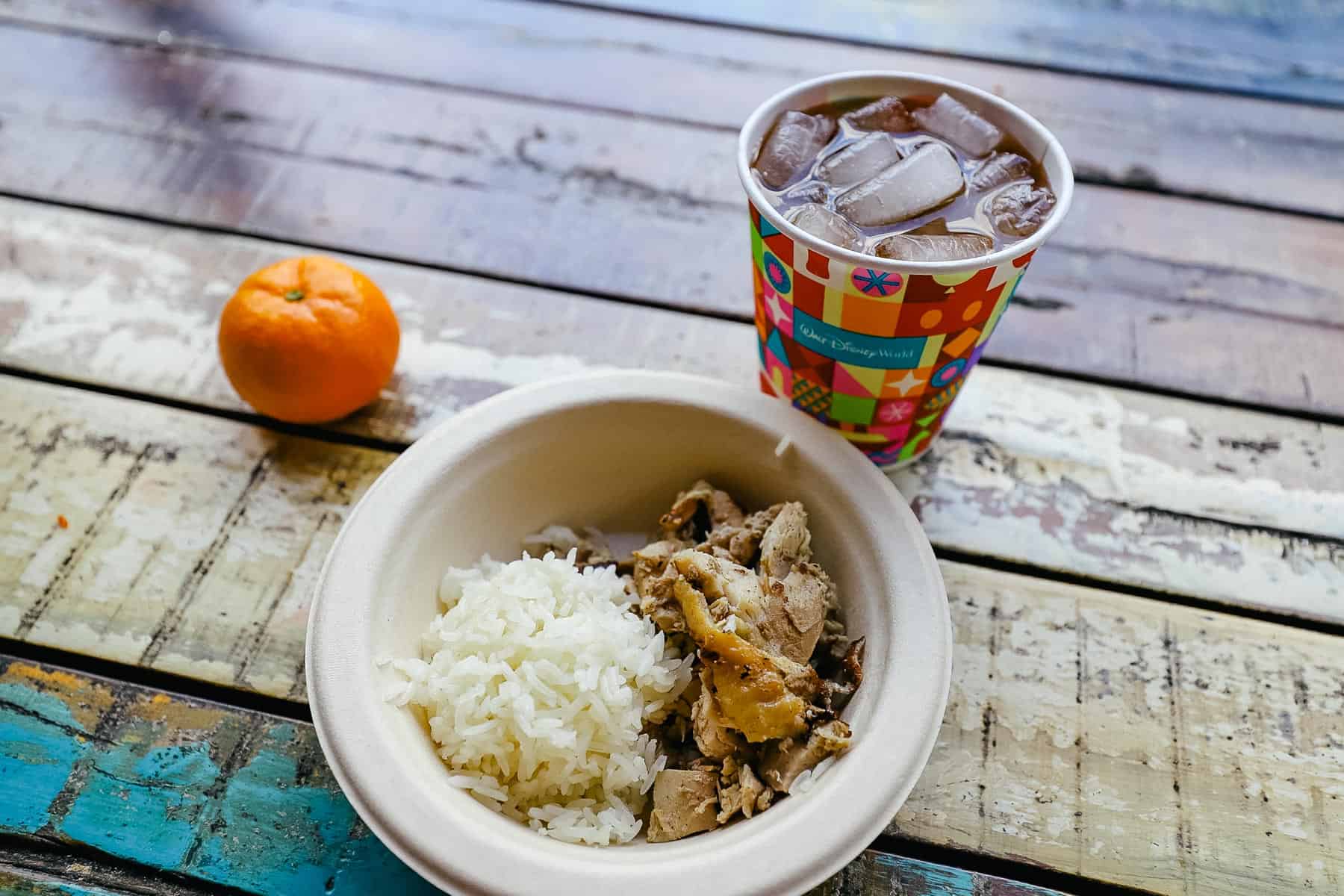 a bowl with rice and chicken from Harambe Market 