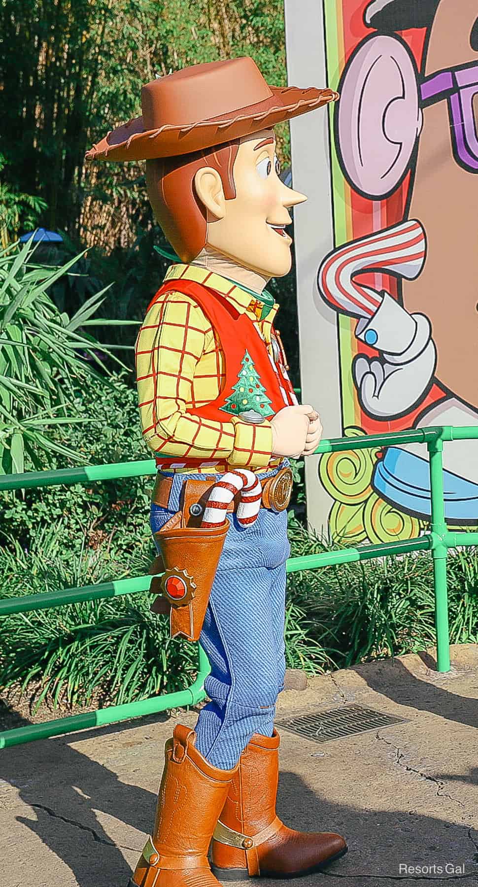 Woody has a Christmas vest and a candy cane in his holster. 