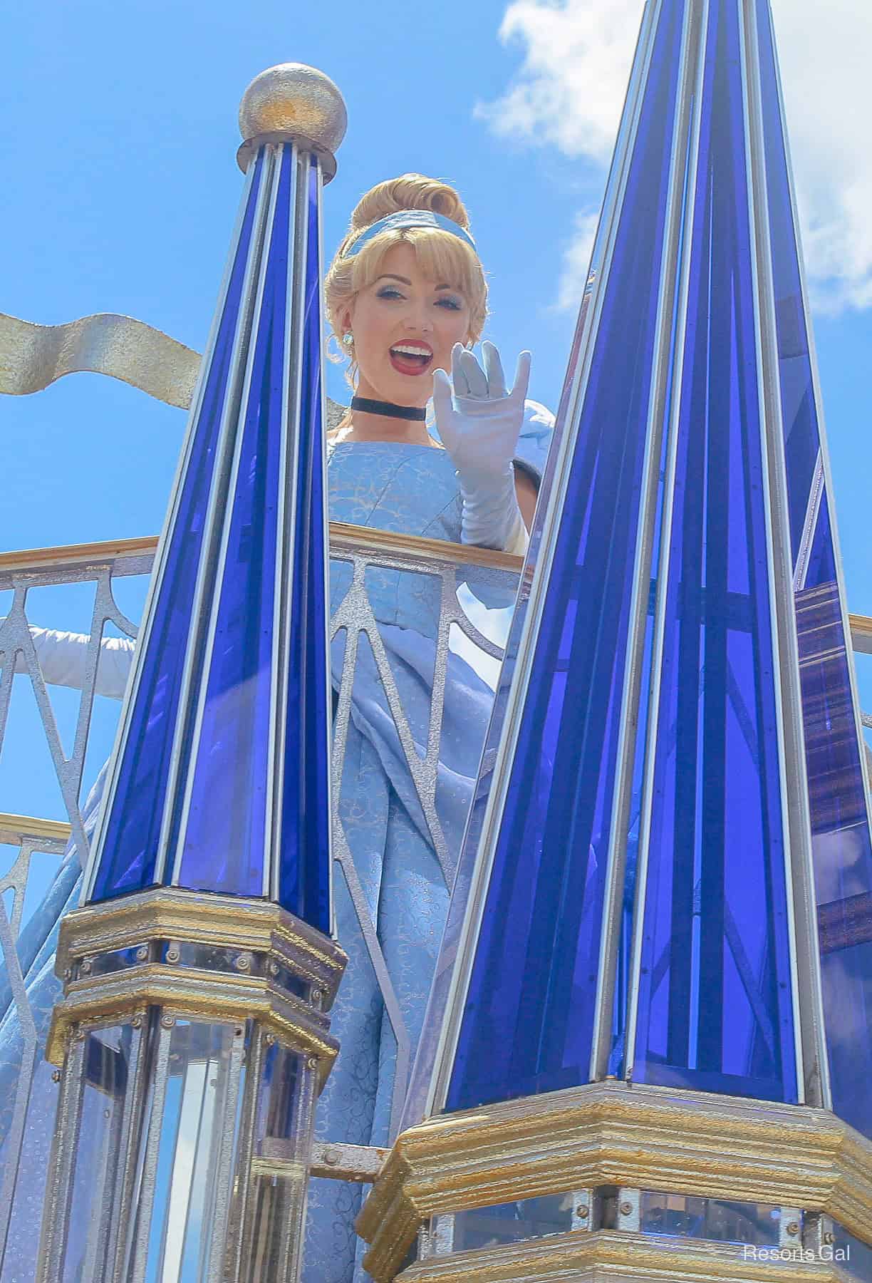 Cinderella waves from a parade float. 