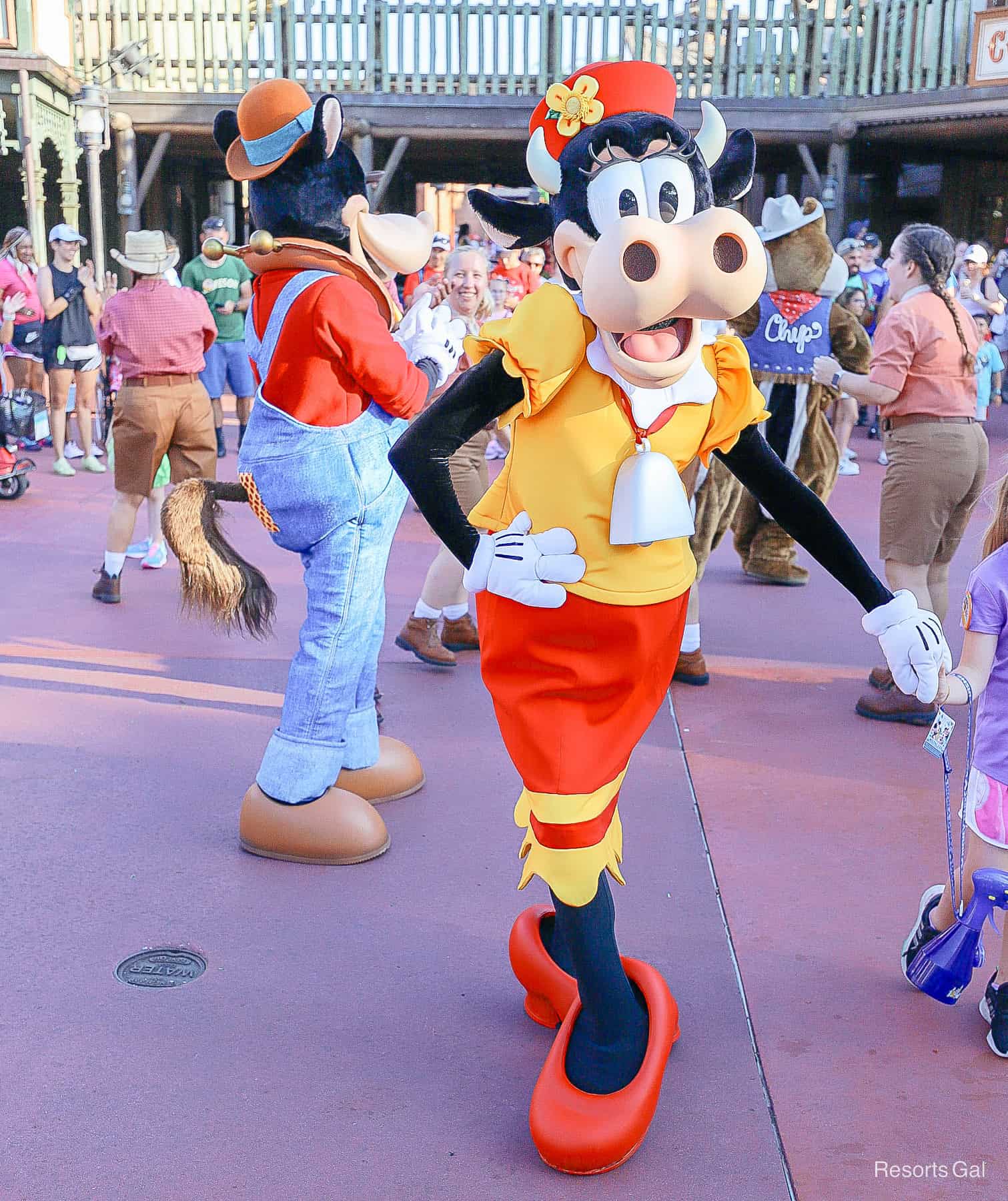 Clarabelle Cow dances with guests in the Frontierland Hoedown at Magic Kingdom 