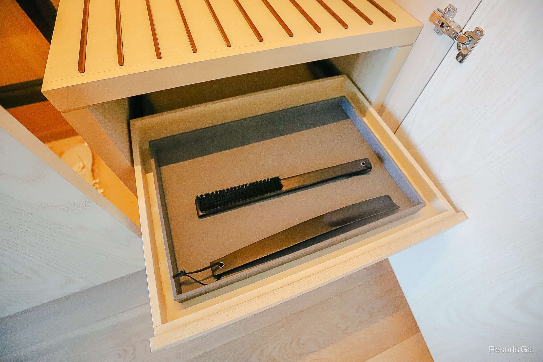 a shoe horn and brush inside a closet drawer at the Conrad Hotel Orlando 