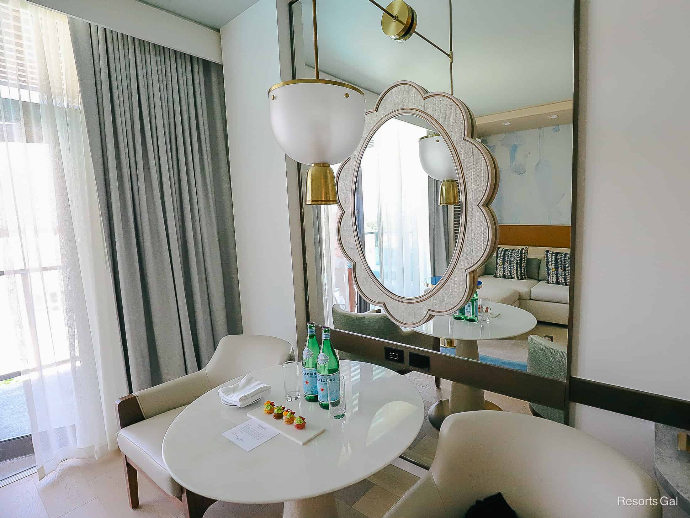 a small table with Pellegrino and macaroons on the room table at the Hilton Conrad Orlando 