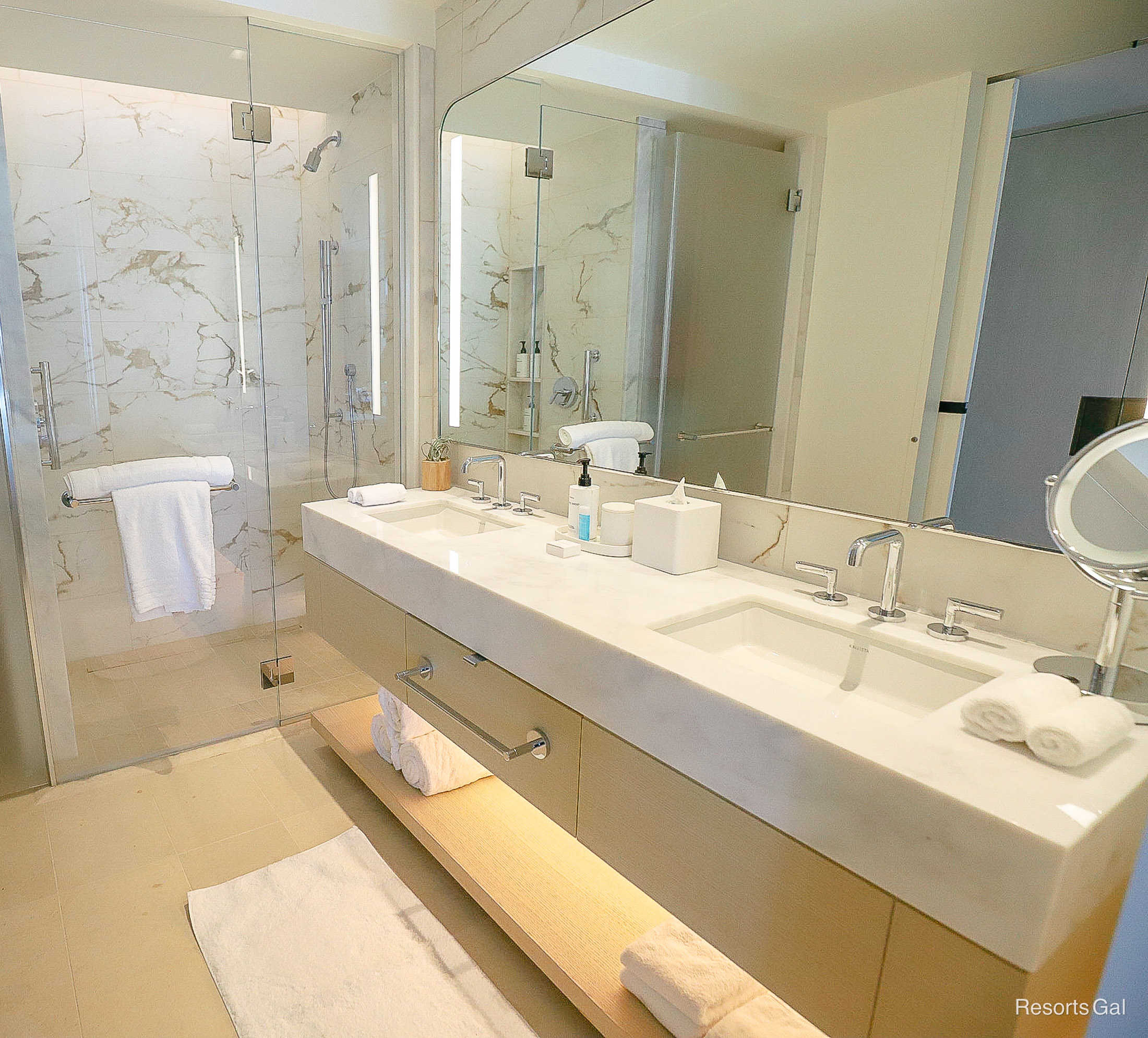 the guest bath with two sinks and a walk-in shower at the Conrad Hilton Hotel near Walt Disney World 