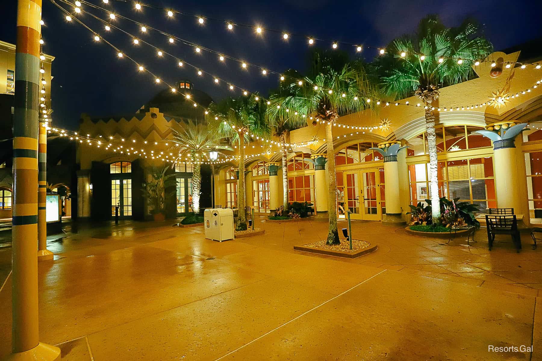 strings of light cast from a pole to a building at night at Disney's Coronado Springs 