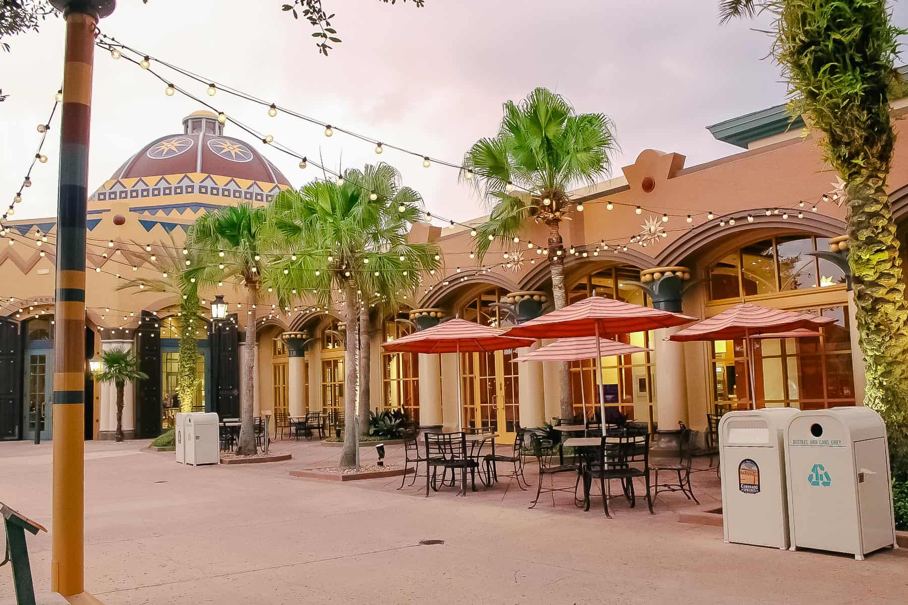 tables with umbrellas at sunset off the lobby of Coronado Springs 