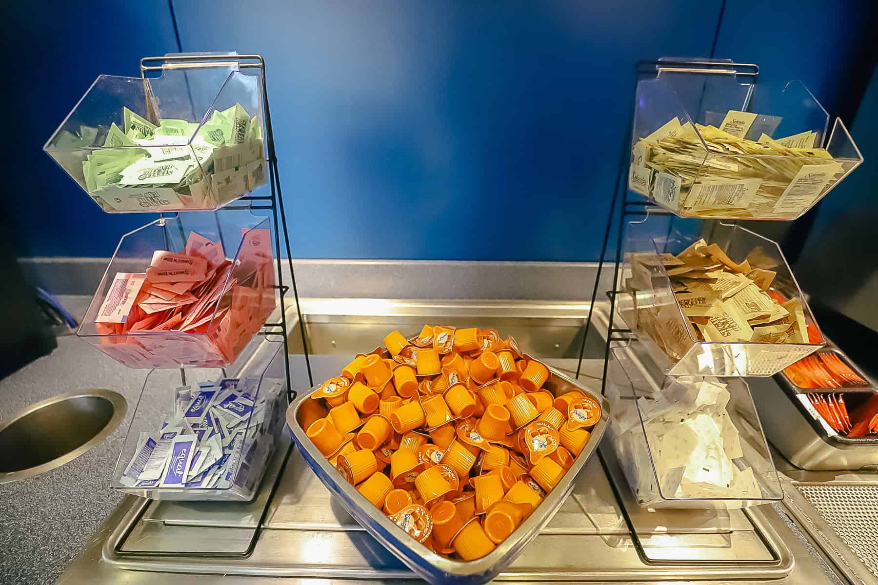 a selection of creamers and sweeteners at the food court 