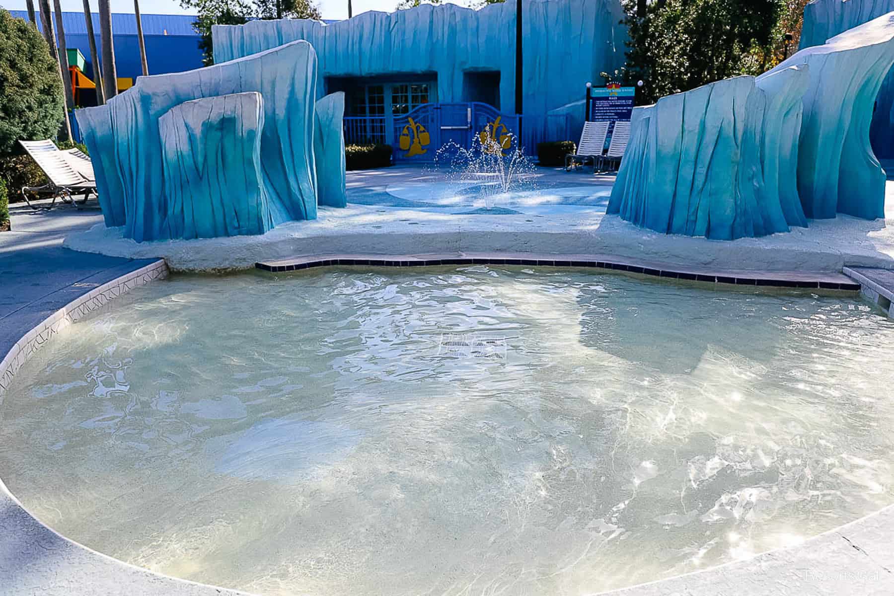 a kiddie pool with a splash pad behind it at Disney's All-Star Movies 