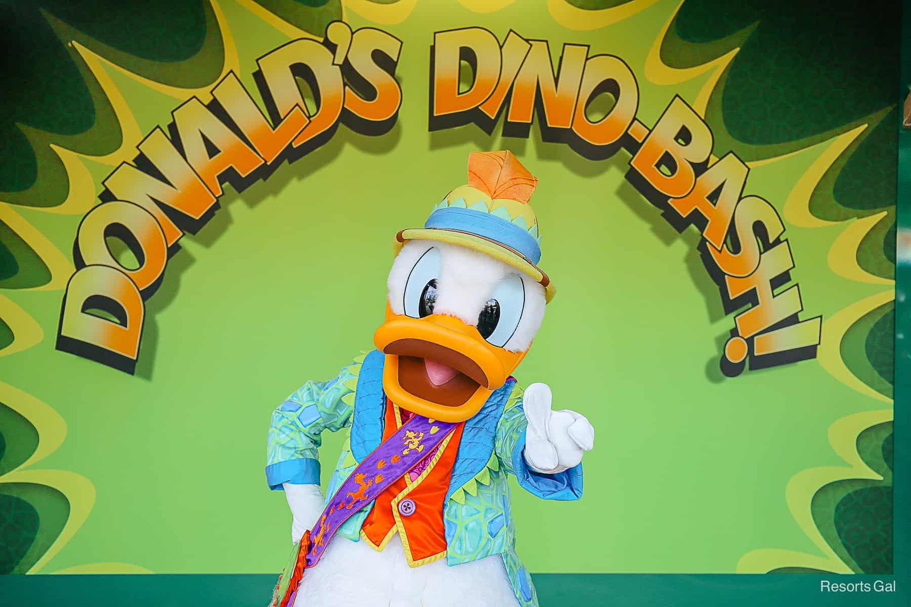 Donald Duck makes the #1 sign with his finger as he poses for a photo. 