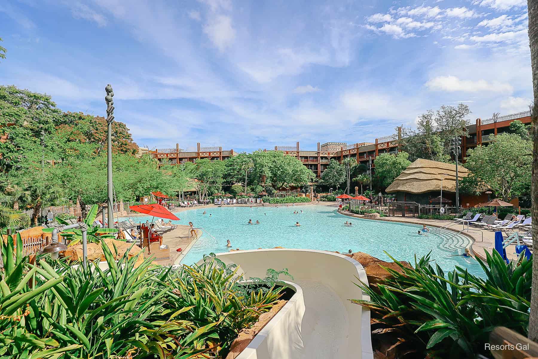 a pool with the Animal Kingdom Lodge hotel in the backdrop 