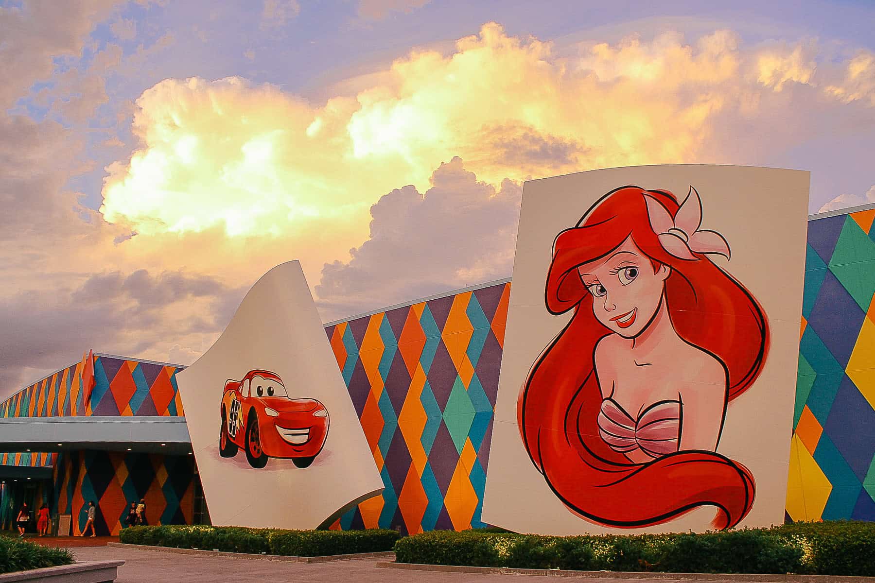 the entrance of Art of Animation at Sunset with Ariel and Lightning McQueen paintings 