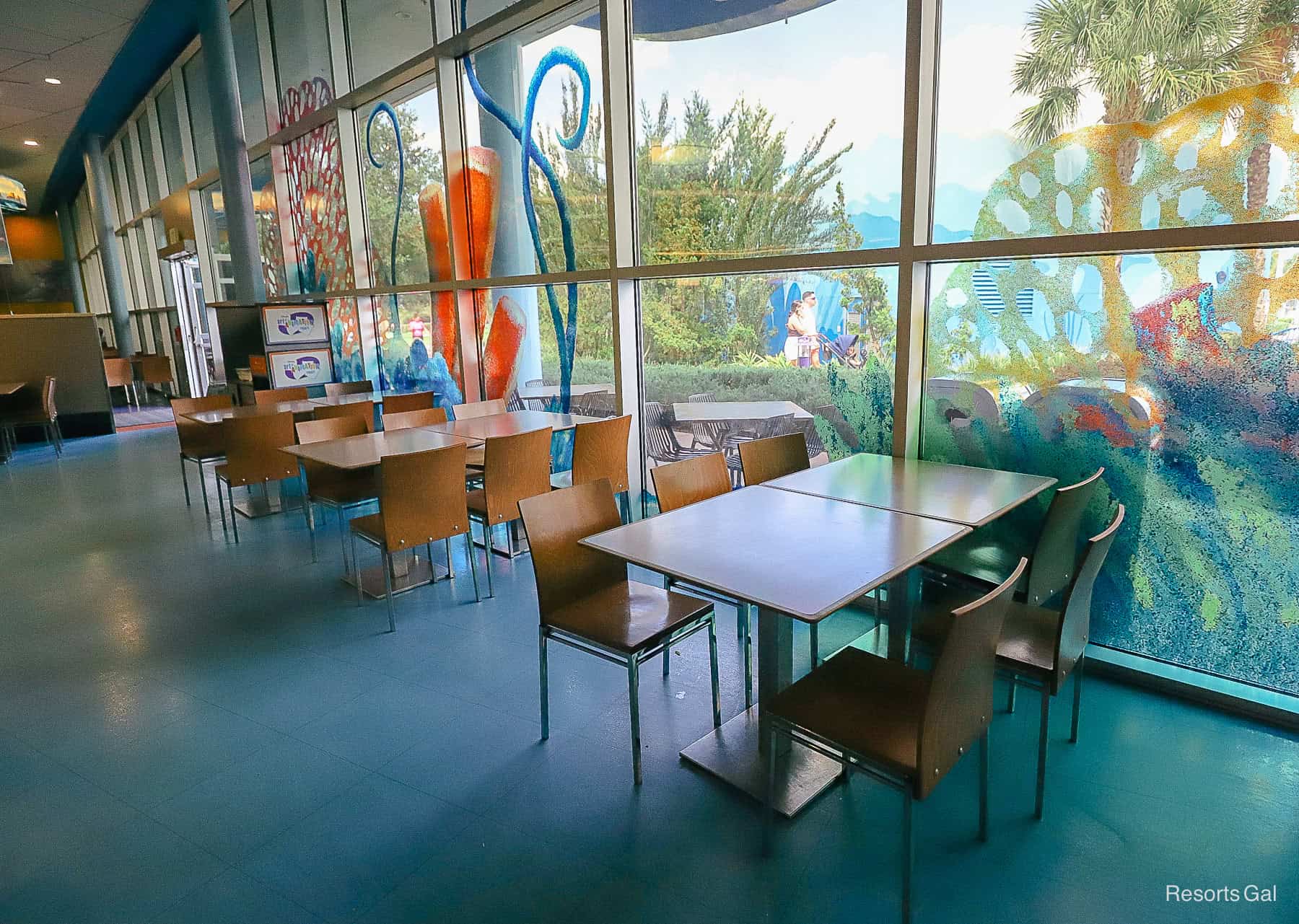 tables and chairs by the window at Art of Animation 