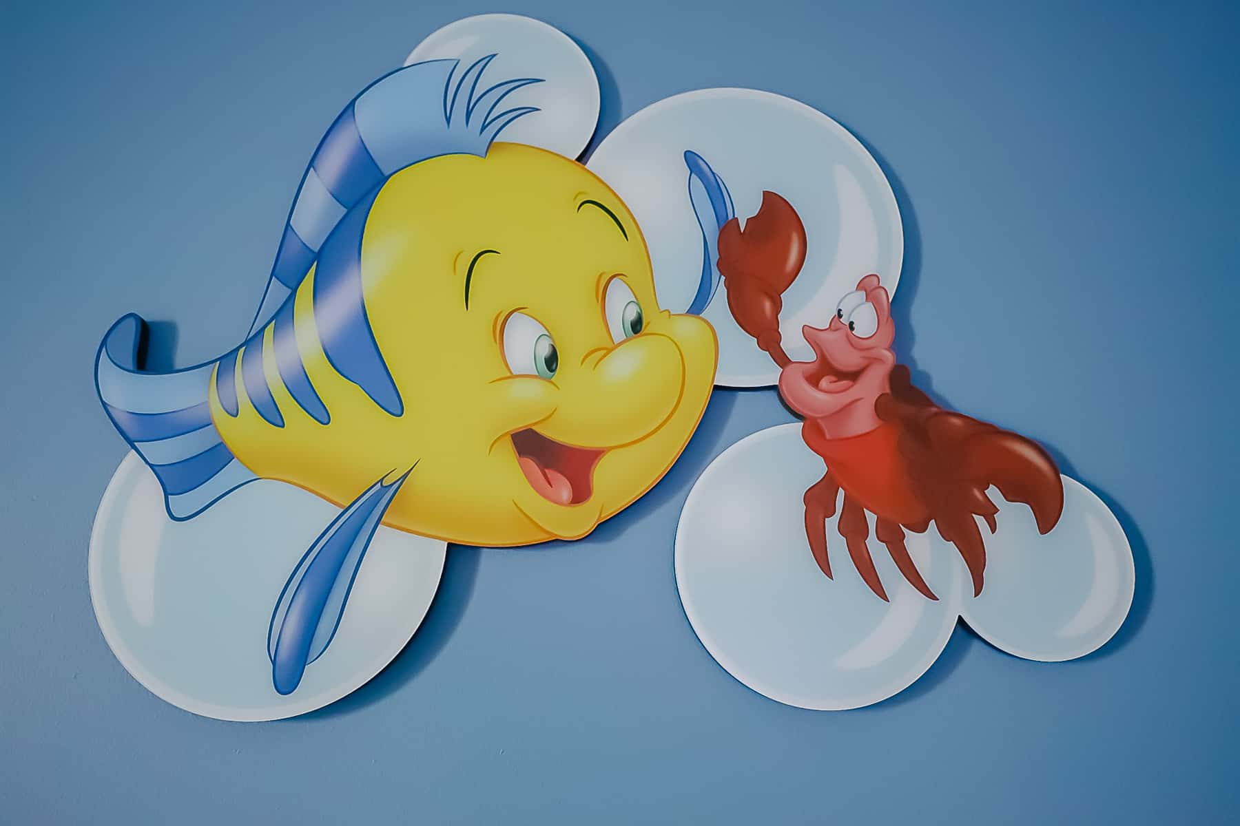 Flounder and Sebastian featured in artwork in the room.