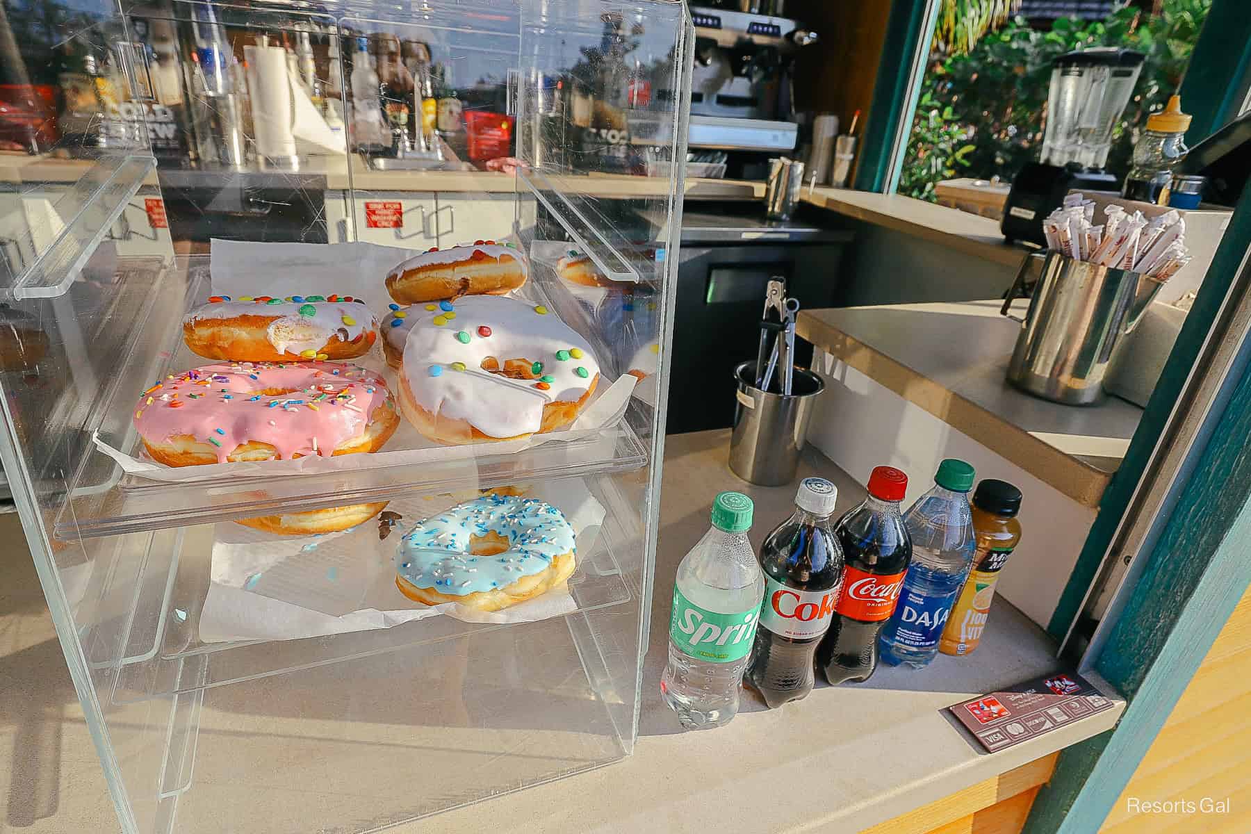 a case with overside donuts with pink, white, and blue icing 