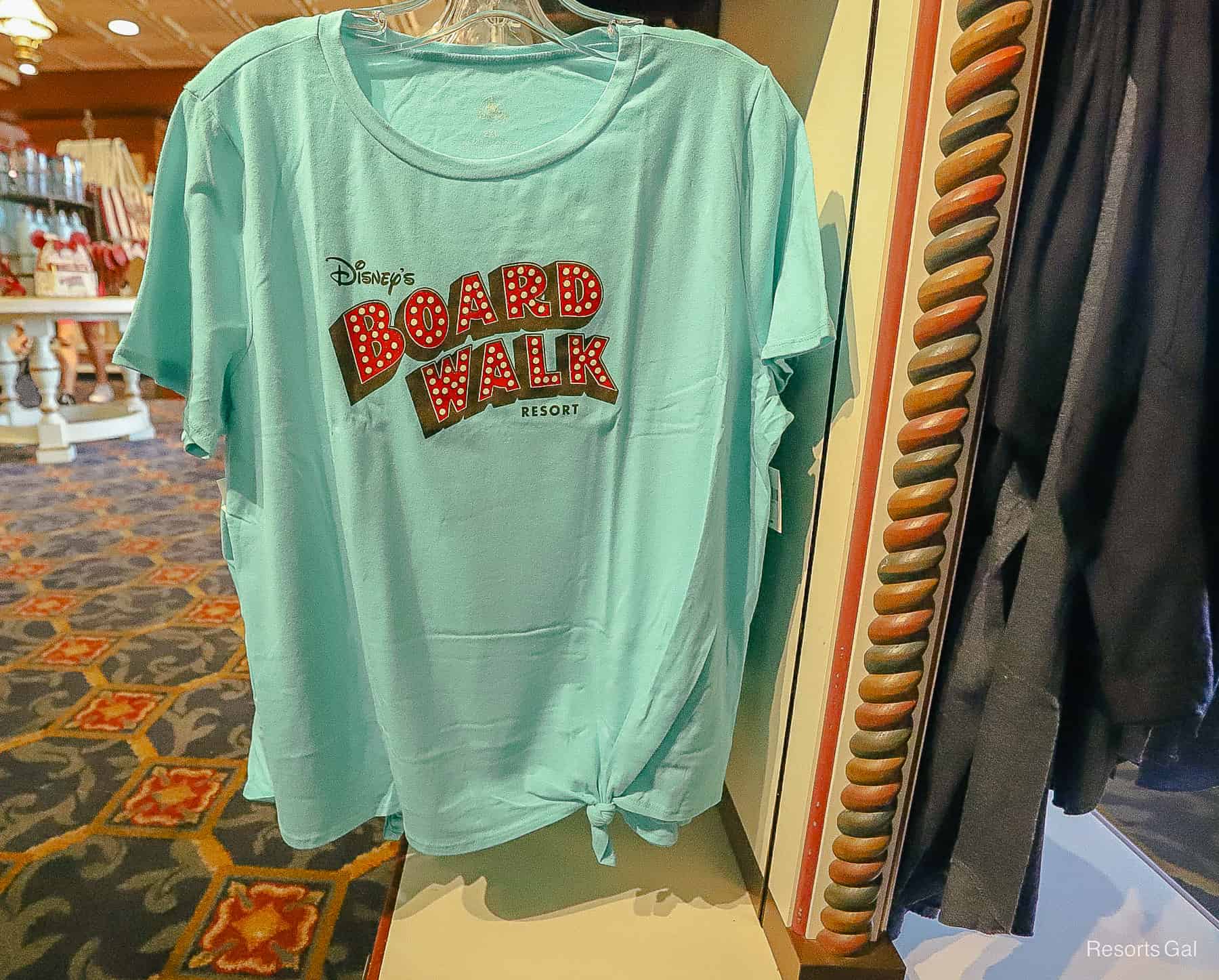 women's Boardwalk T-shirt in blue-green color with red logo 