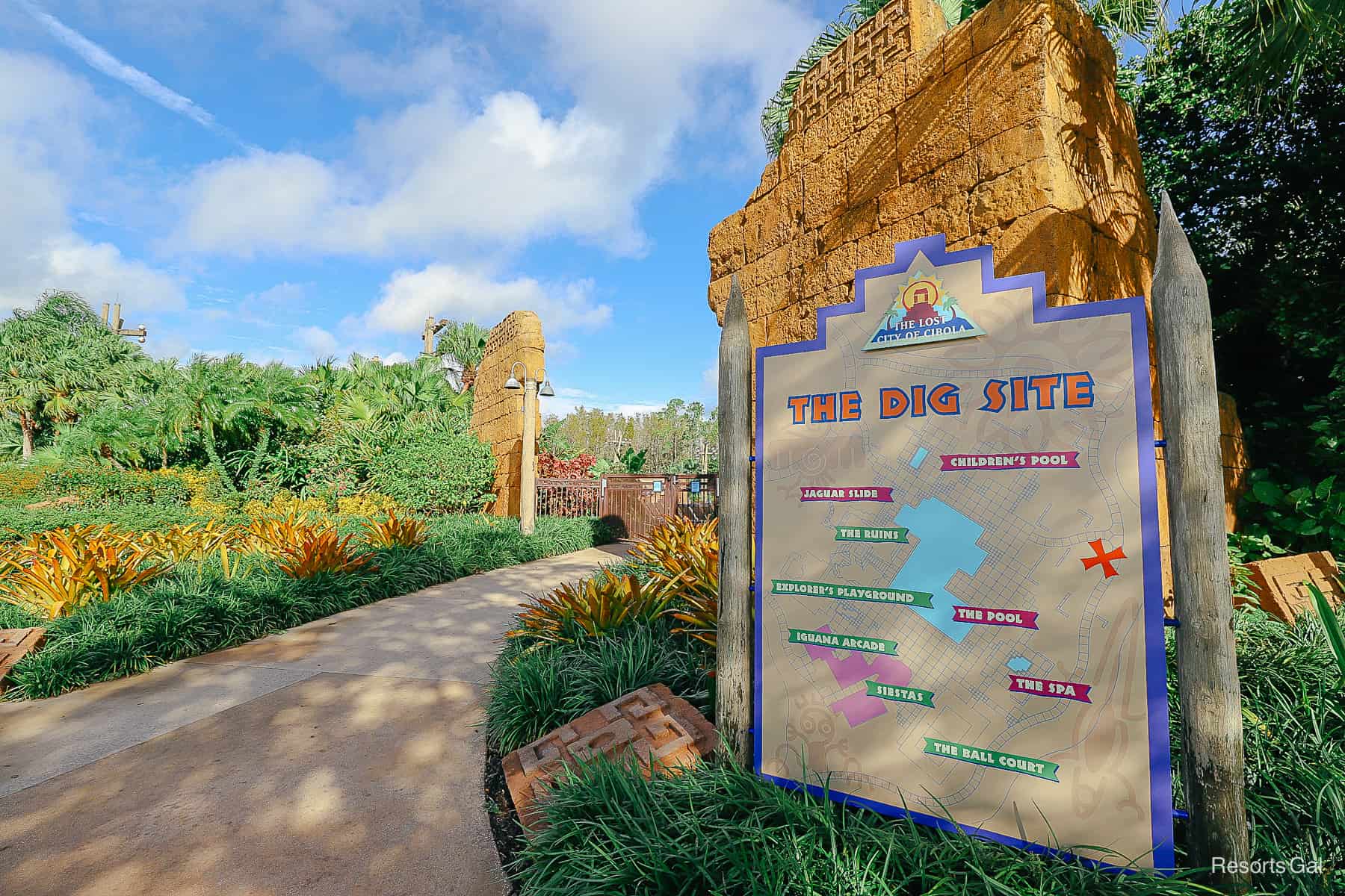 a sign in front of the Dig Site with a map of the pool area 