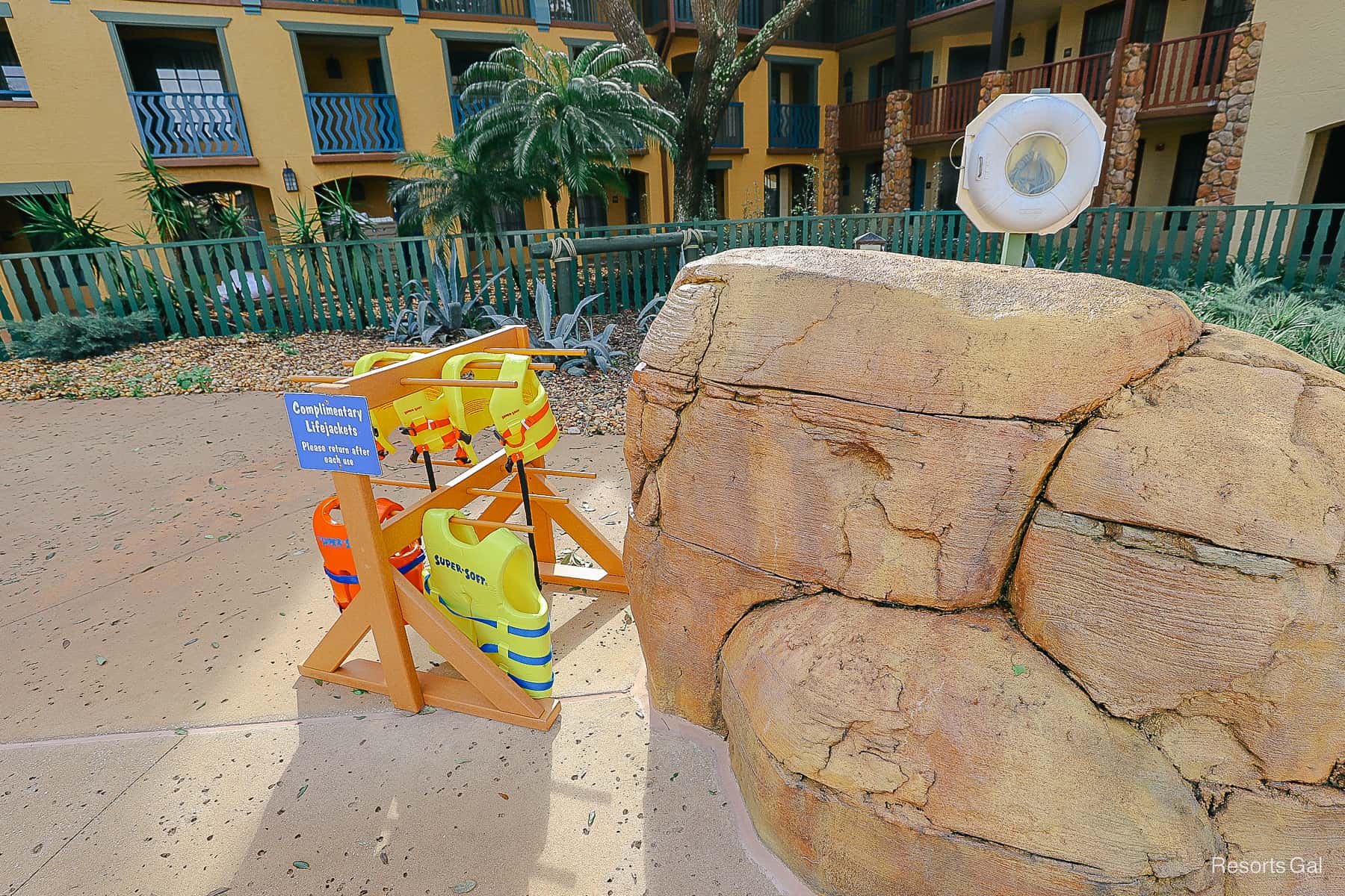 a stand with life jackets sitting next to a rock at the Coronado Springs Pool 