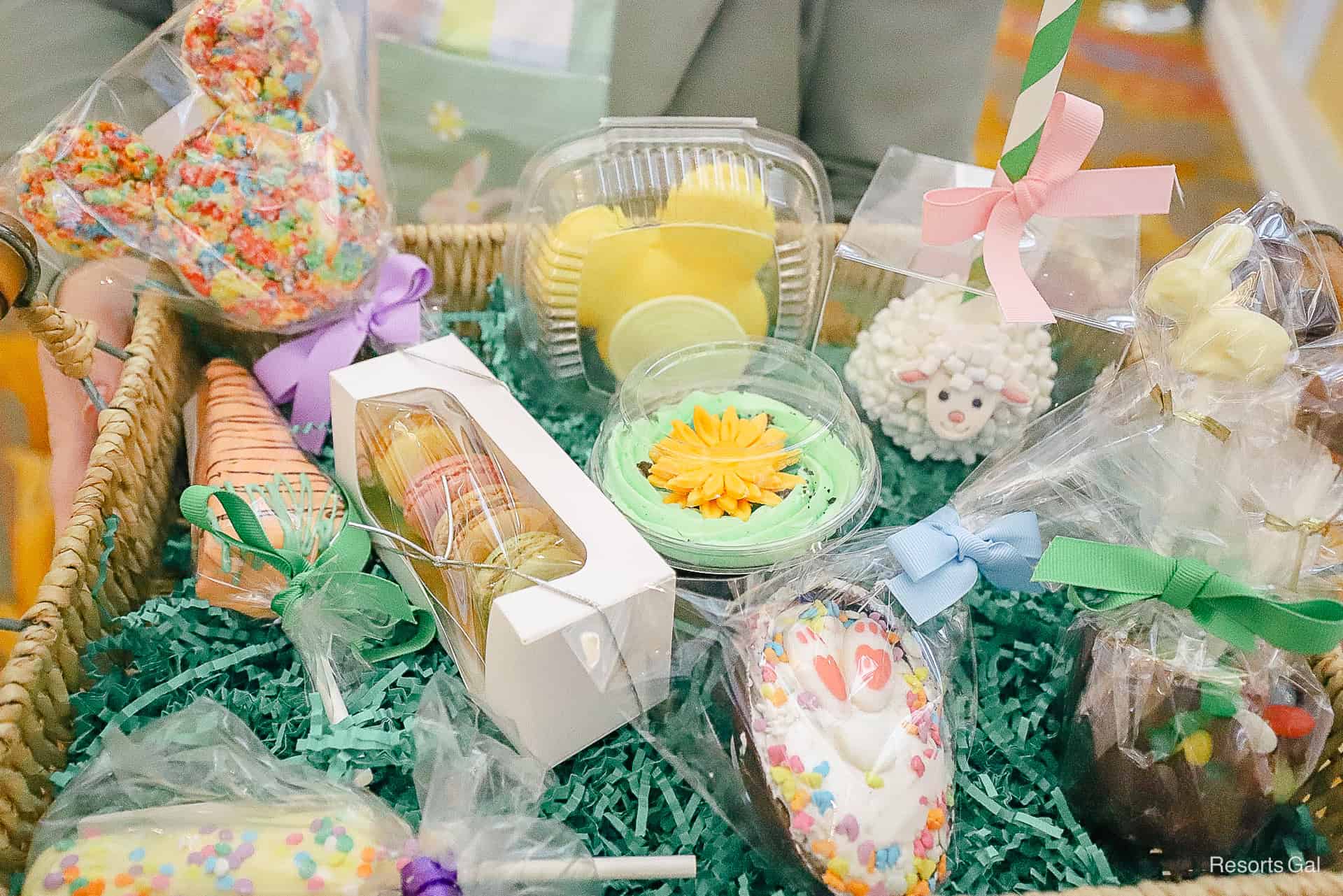 a cast member holding a basket with faux green grass that's filled with Easter treats 