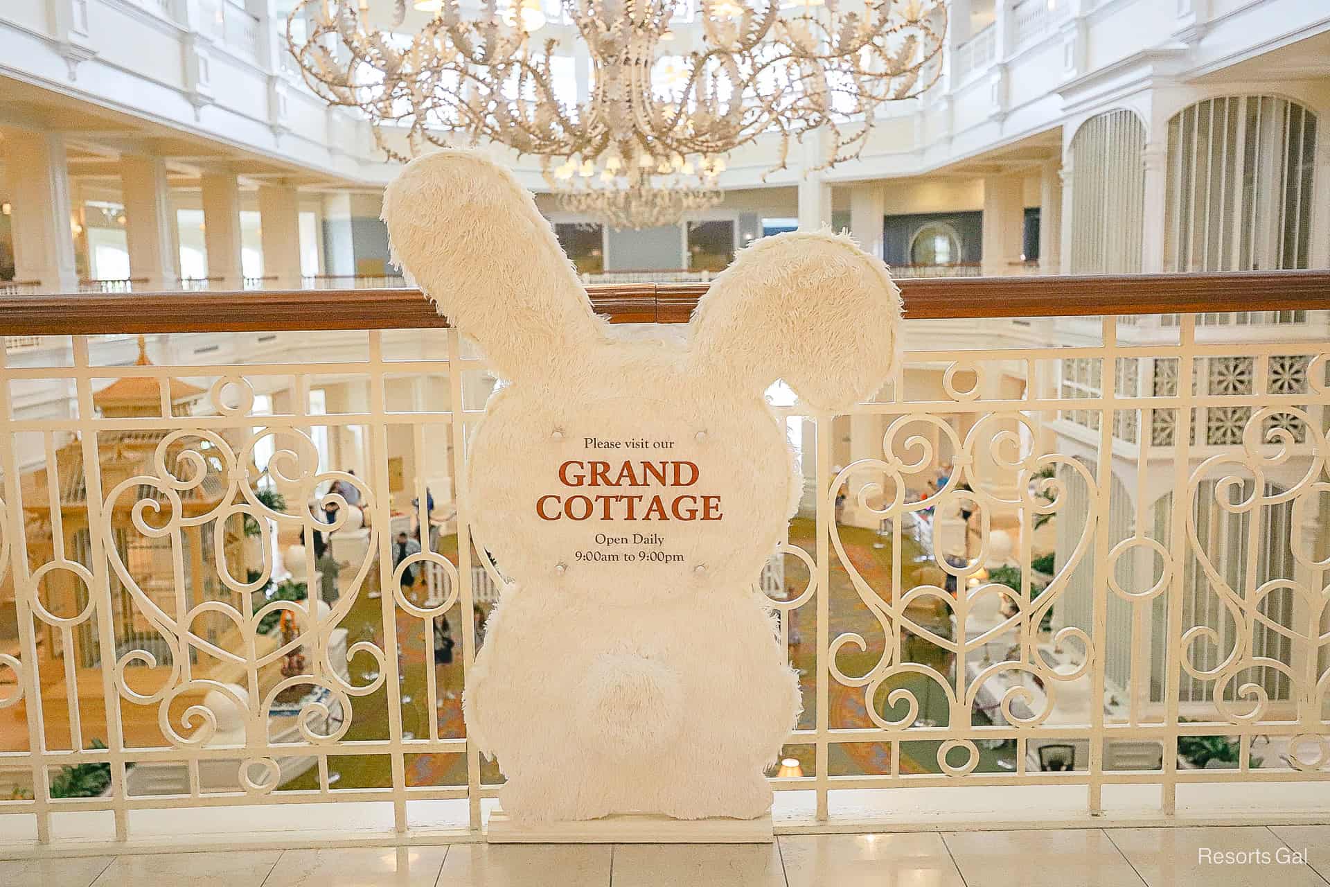 a sign shaped like a bunny rabbit that lists the hours 9:00 a.m. to 9:00 p.m for the Grand Cottage 