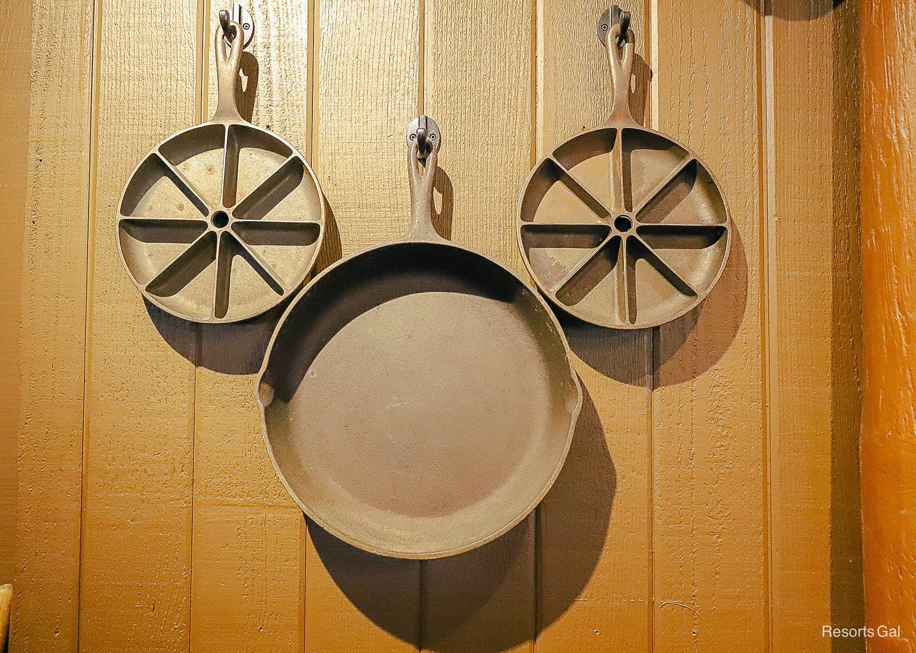 a pairing of cast iron skillets shaped like a Mickey Mouse 