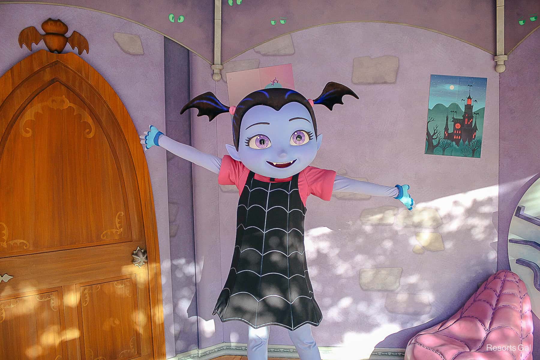 Vampirina poses with arms out in her spider web dress at Disney's Hollywood Studios.