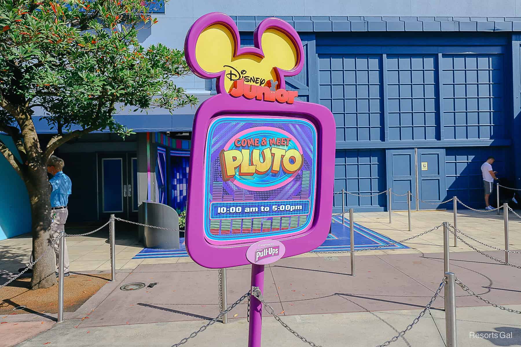 Disney Junior sign that says Come and met Pluto with the times. 