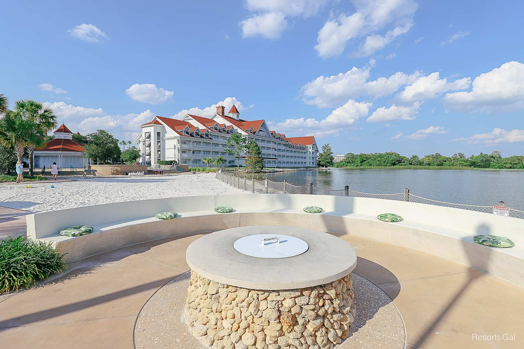 a fire pit with the Grand Floridian in the background 