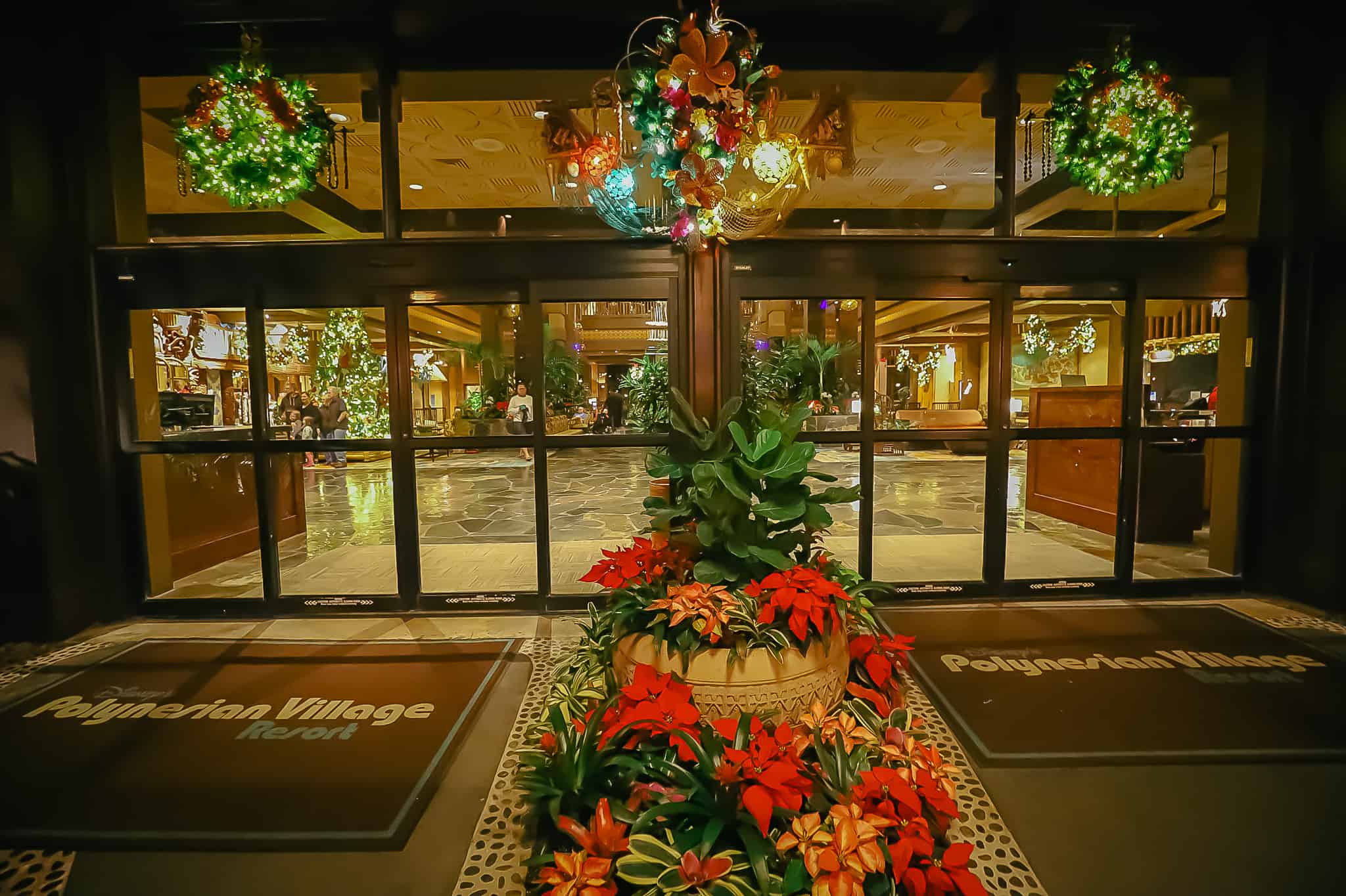 The front door entrance of the Polynesian has wreaths over the transoms. 