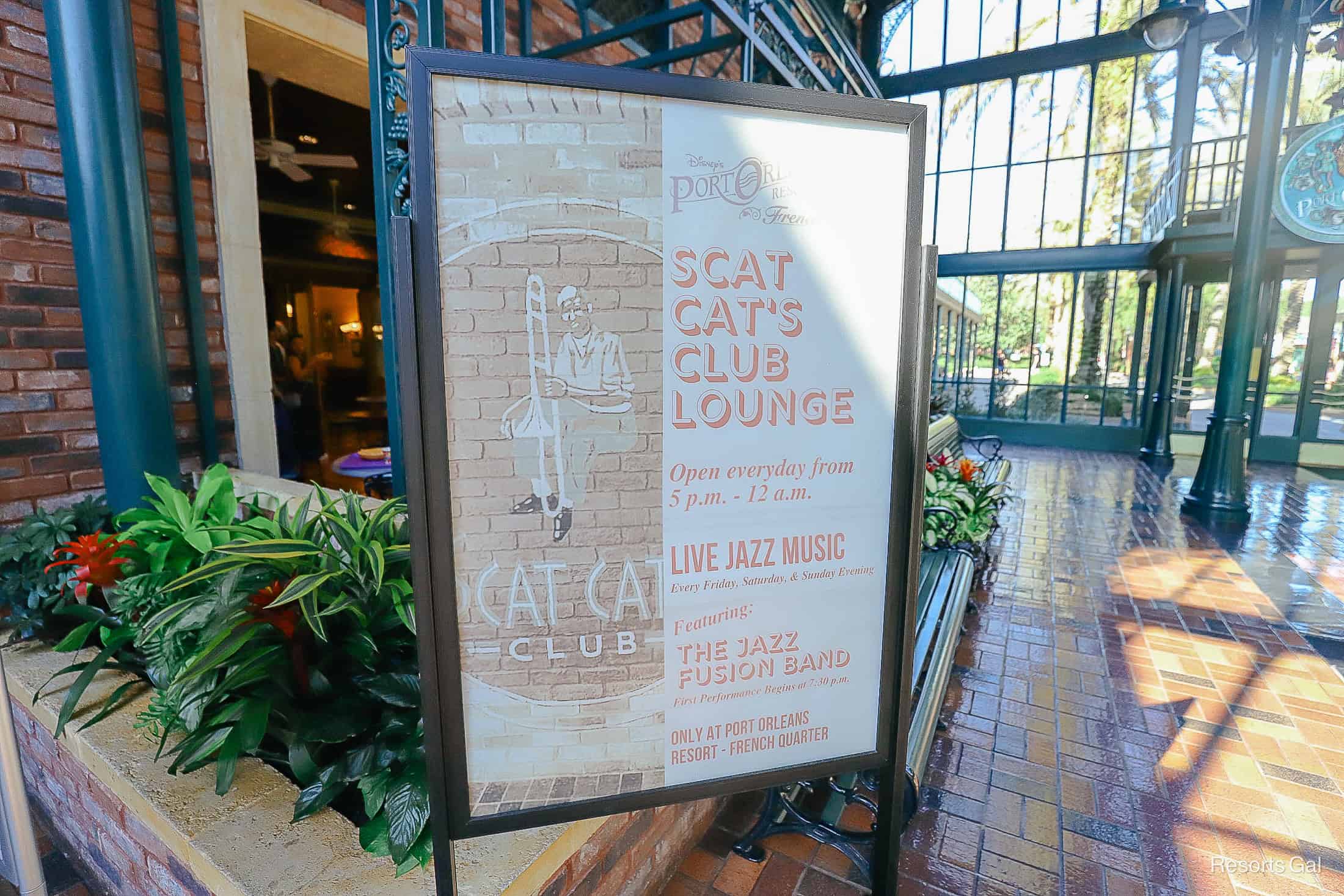 a sign that lists the hours and live entertainment for Scat Cat's Club Lounge 