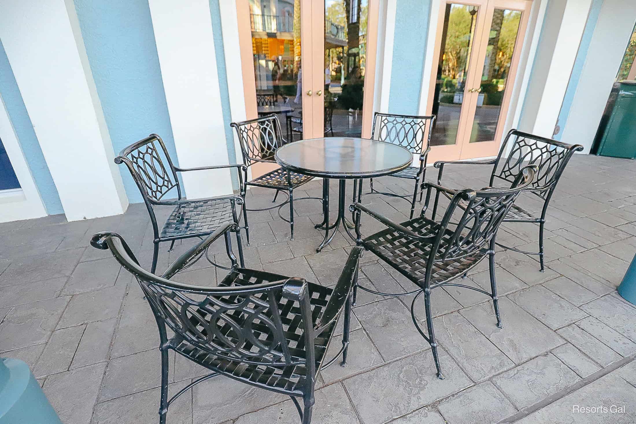 a wrought iron table and chairs outside the dining areas 