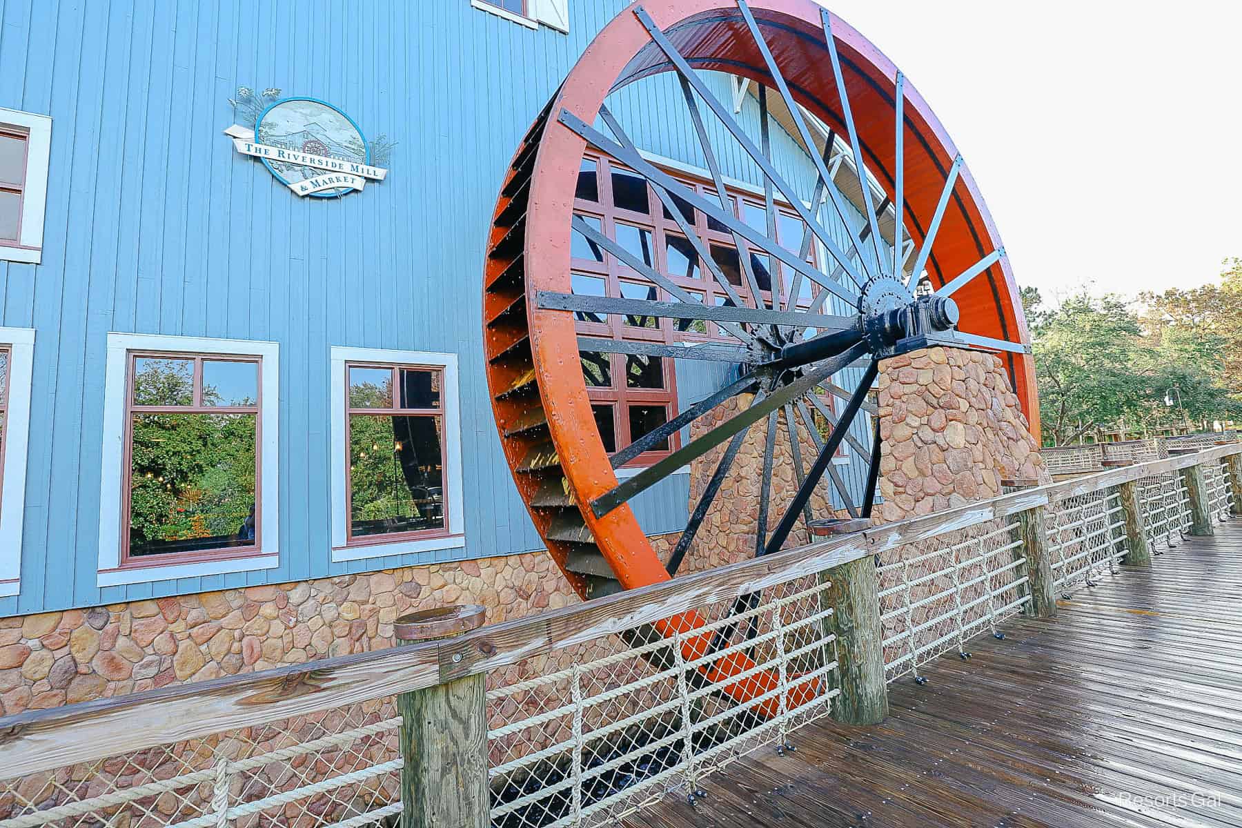 the red water wheel in front of the Riverside Mill and Market