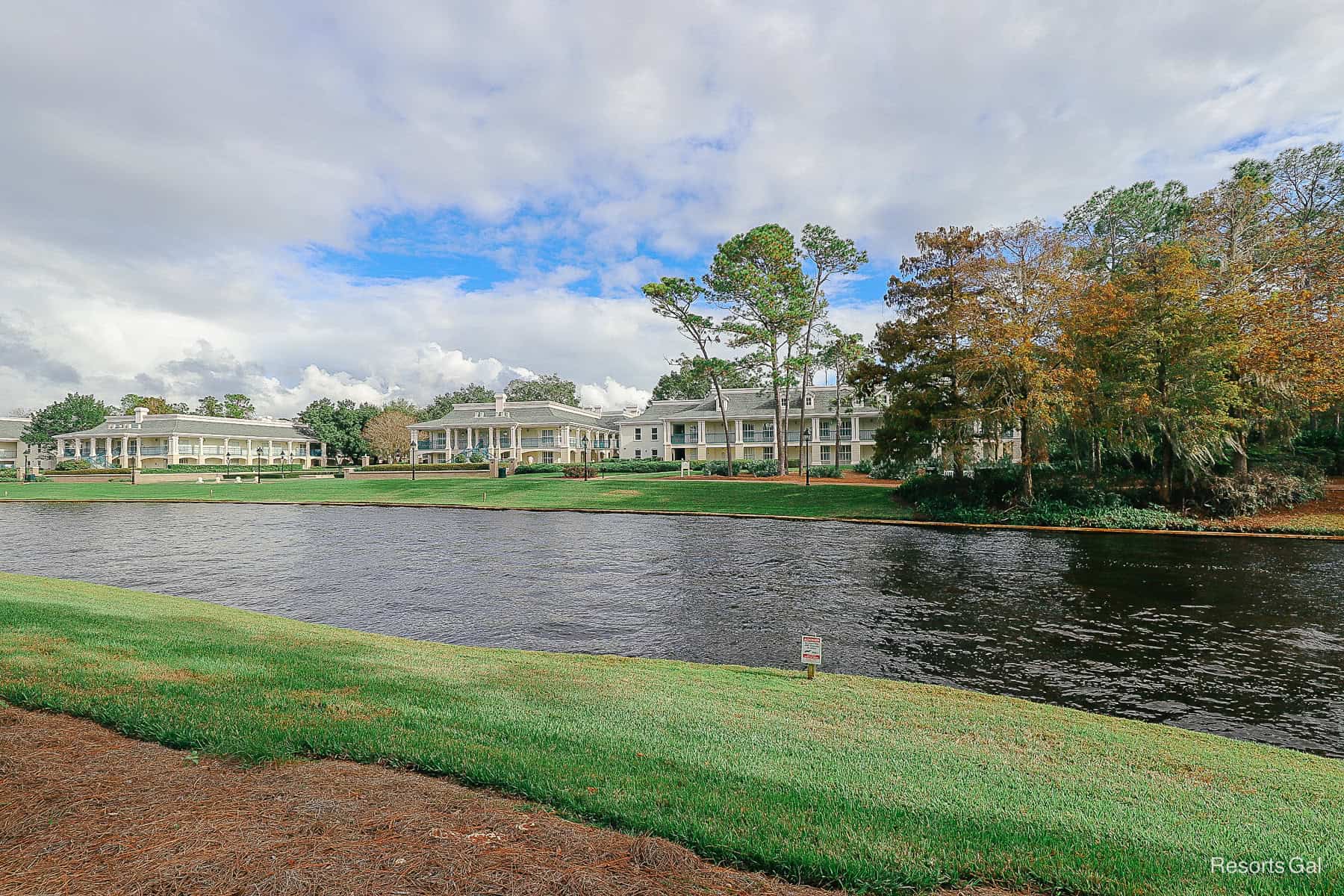 a view of the walking path along the river at Port Orleans Riverside with the mansions in the backdrop 