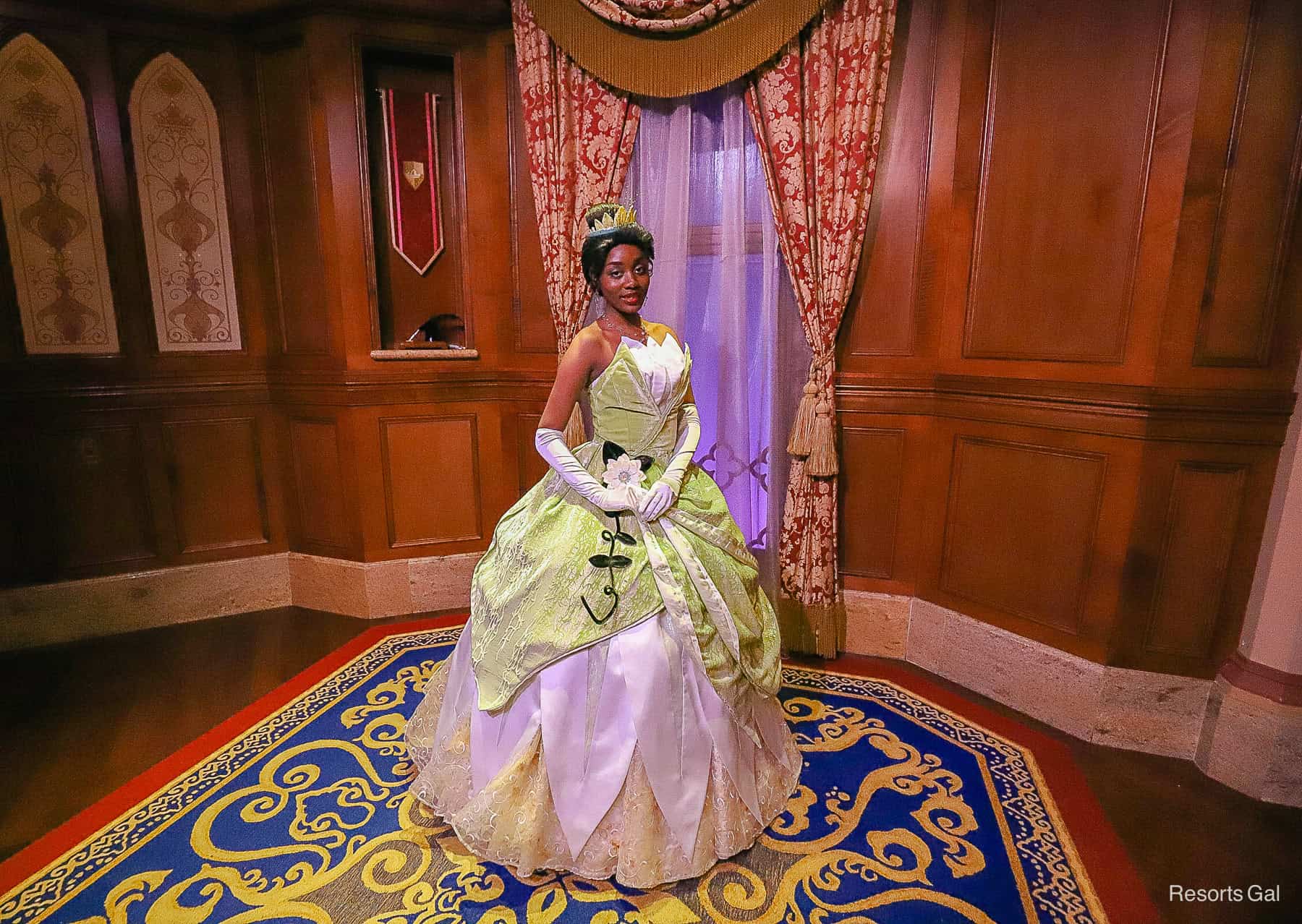 Princess Tiana at Magic Kingdom in her green ball gown with magnolia accents. 