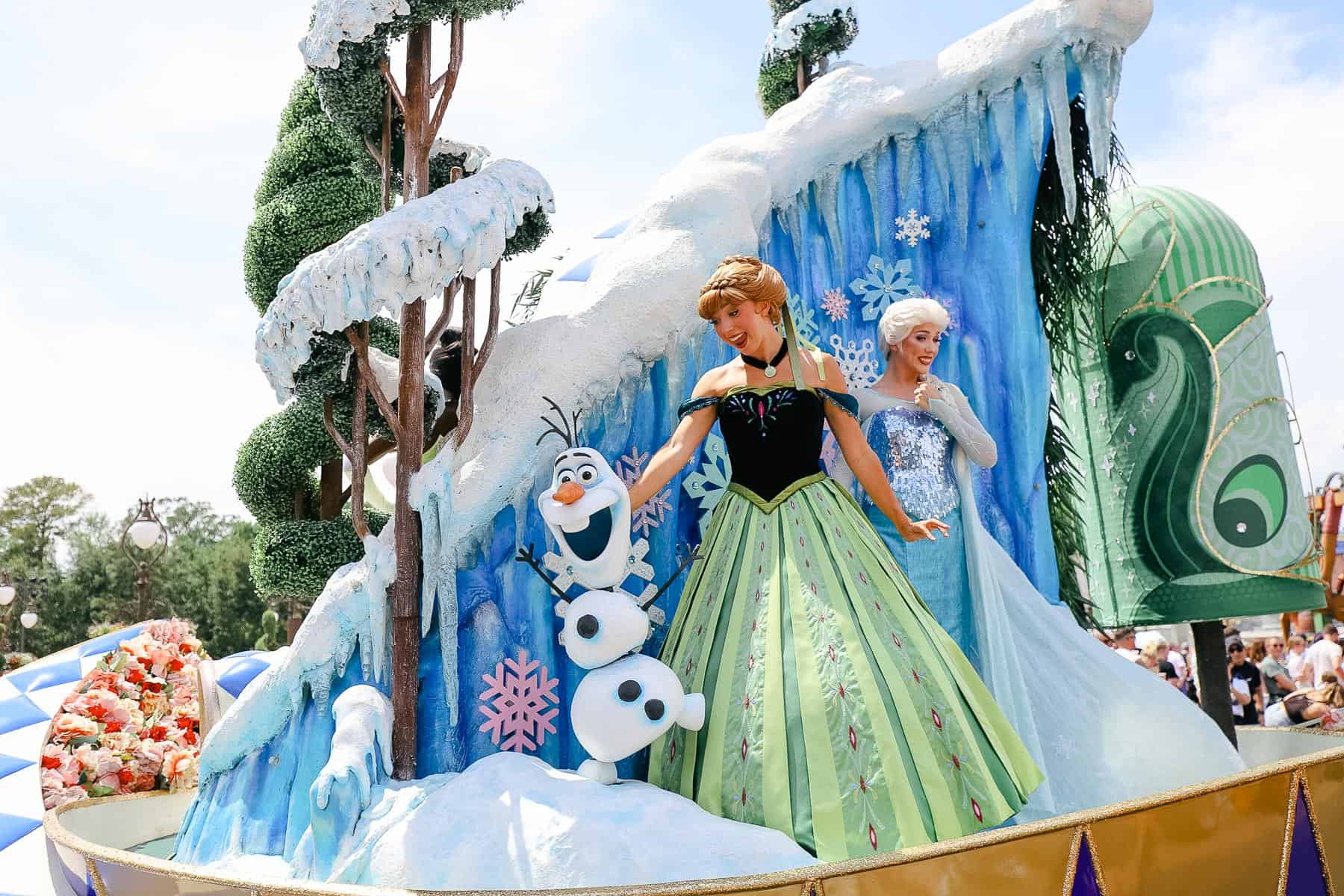 Anna with Elsa riding in the Festival of Fantasy Parade at Magic Kingdom 