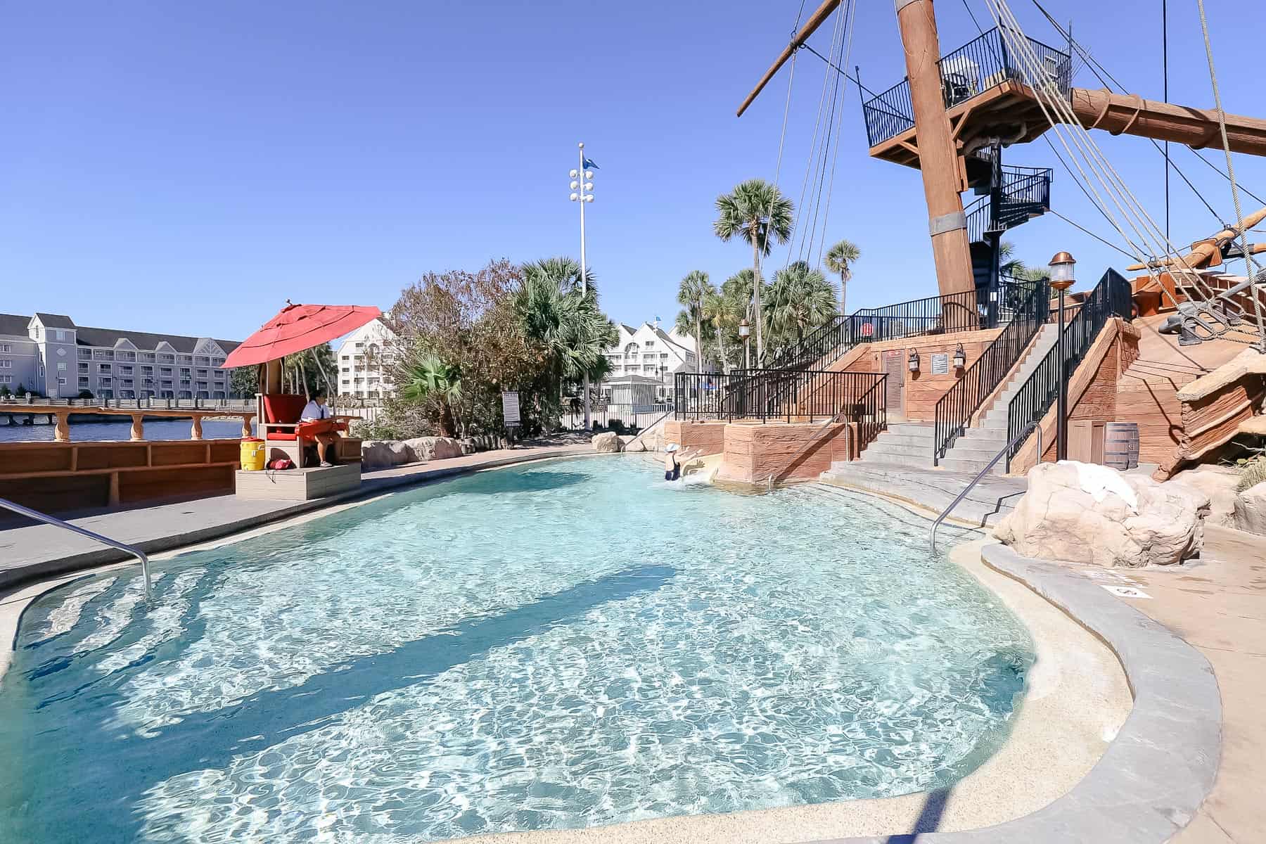 a faux shipwreck with a kiddie pool in the base of it 