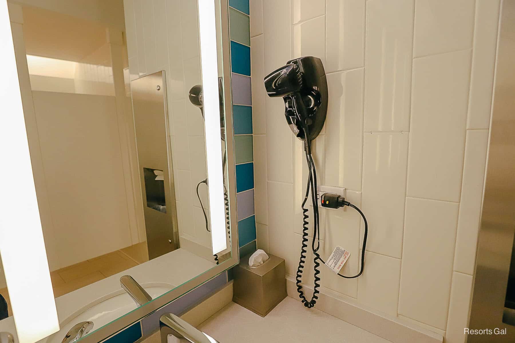 a hairdryer by the sink 