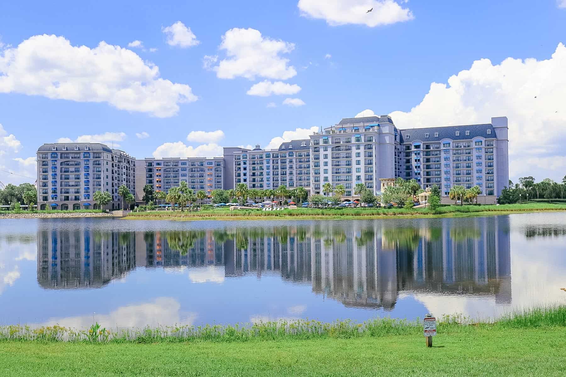 a scenic photo of Disney's Riviera Resort sitting behind a lake 