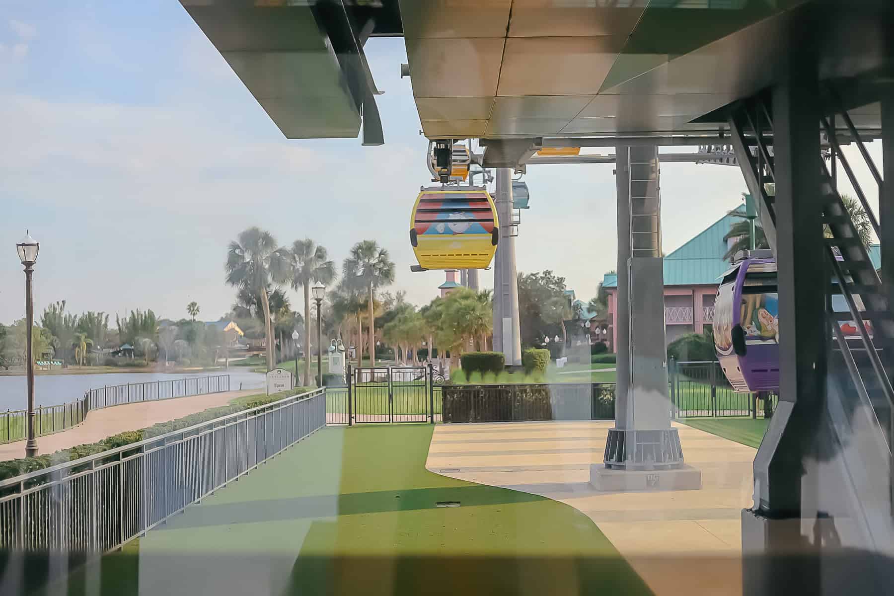 a yellow Skyliner Gondola preparing to land at Disney's Riviera 