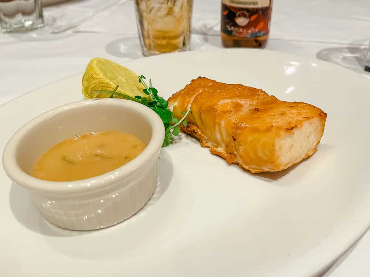 an entree with halibut and sauce from Shula's Steakhouse a fine dining location at Walt Disney World 