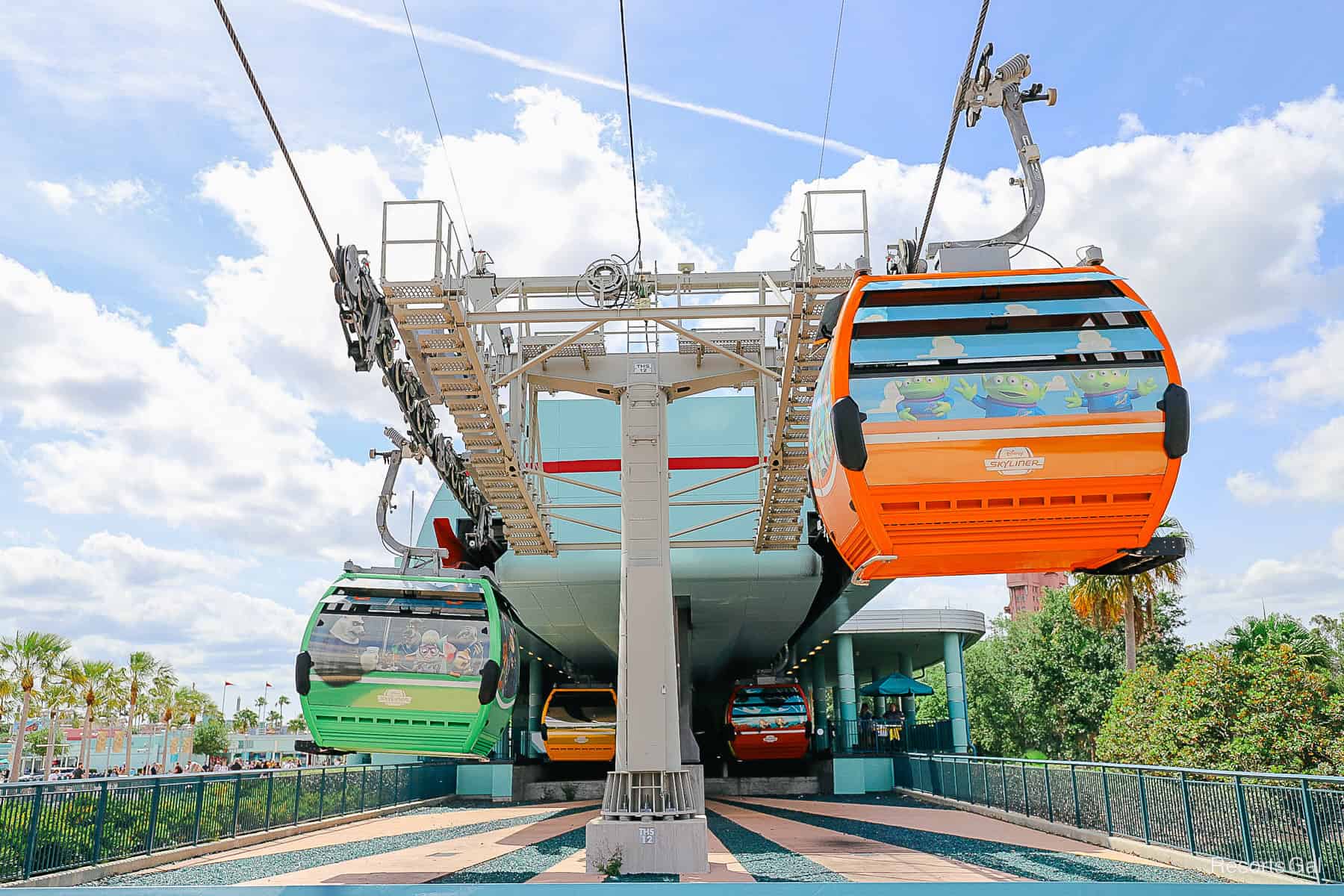 Skyliner Station at Disney's Hollywood Studios with an orange and green gondola 