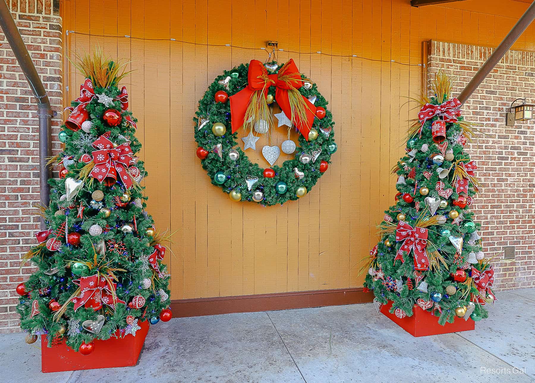 a pair of Christmas trees and wreaths at at Disney Springs 