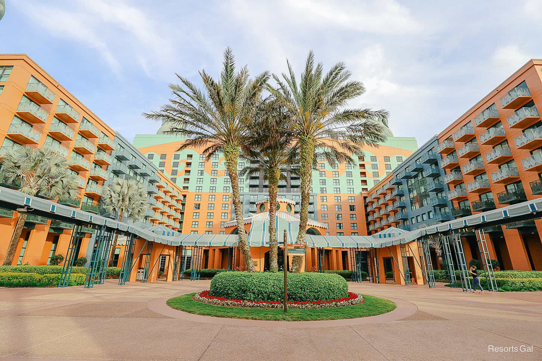 The Swan Hotel with palm trees in front of it. 